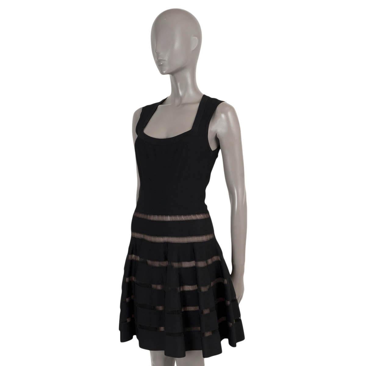 100% authentic Alaïa flared knit dress in black viscose (73%), polyester (17%), silk (6%) and cotton (4%). Features sheer strip panels on the skirt and a scoop neck. Opens with a zipper in the back. Unlined. Has been worn and is in excellent