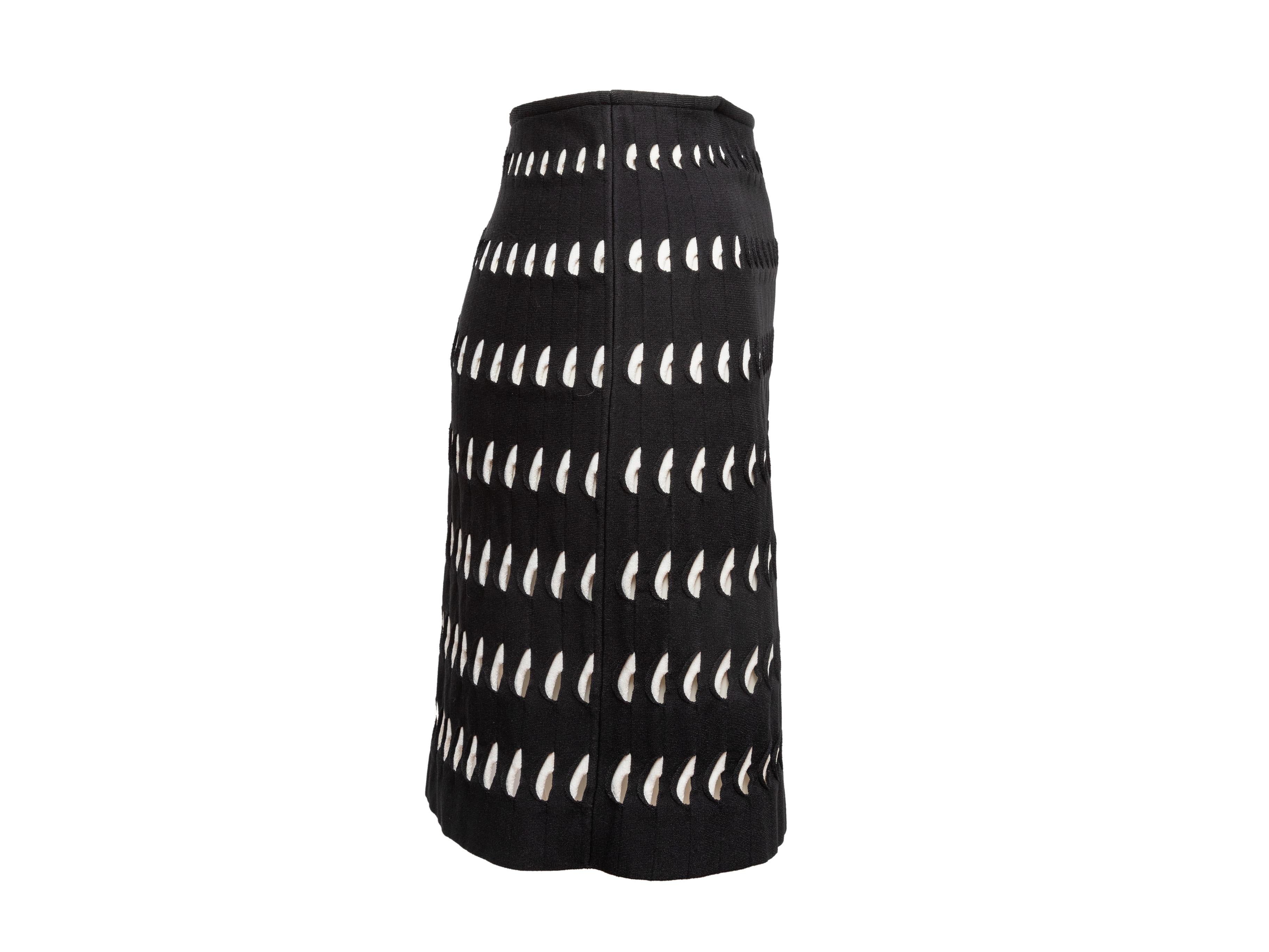 Product Details: Black and white cutout pleated skirt by Alaia. Elasticized waistband. 26