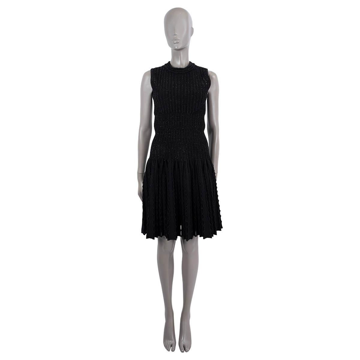 100% authentic Alaïa sleeveless flared cut-out dress in black fleece wool (60%), polyamide (20%), viscose (10%) and polyester (10%). The design features lurex threads and cut-out details on the top and skirt part.  Unlined. Opens with a concealed