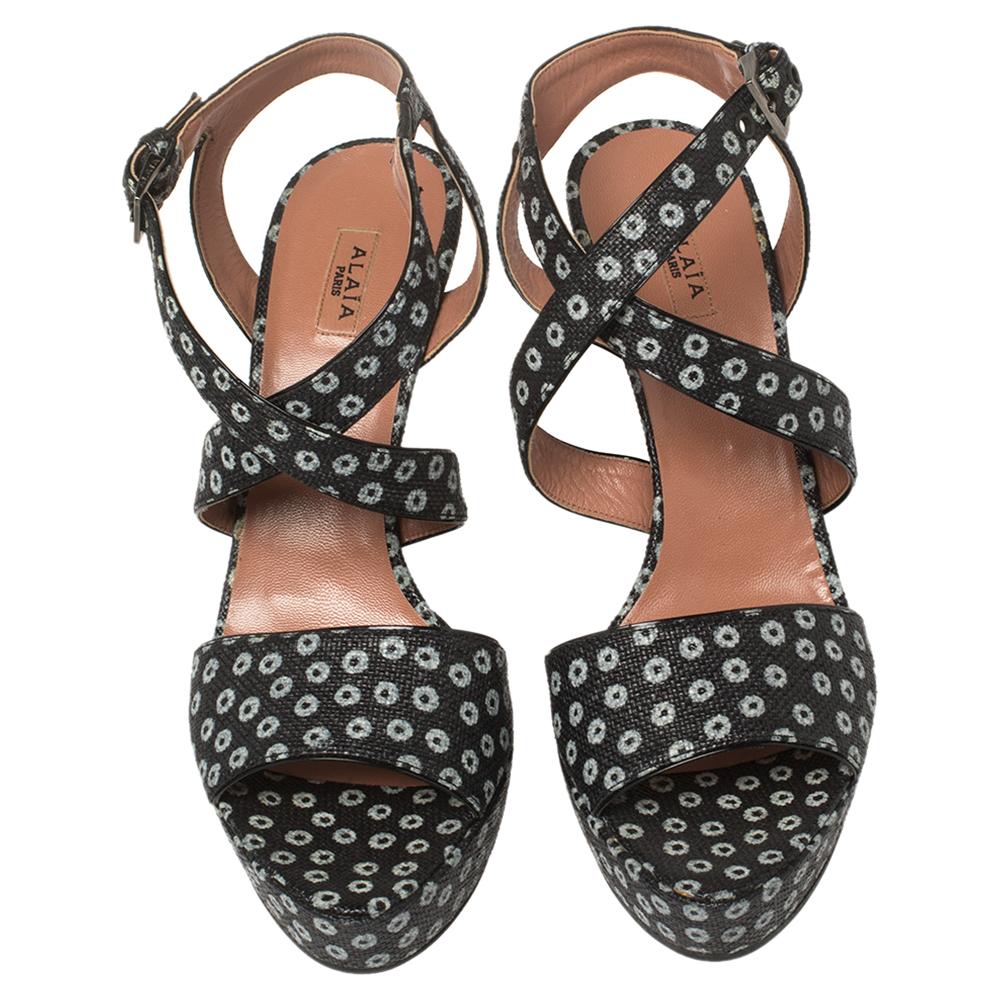 These pretty and stylish Alaia sandals are just what you need to amp up your ensembles. Crafted in Italy from canvas, they feature floral prints all over and a criss-cross design. Elevated on 12 cm heels, these sandals are supported by platforms.

