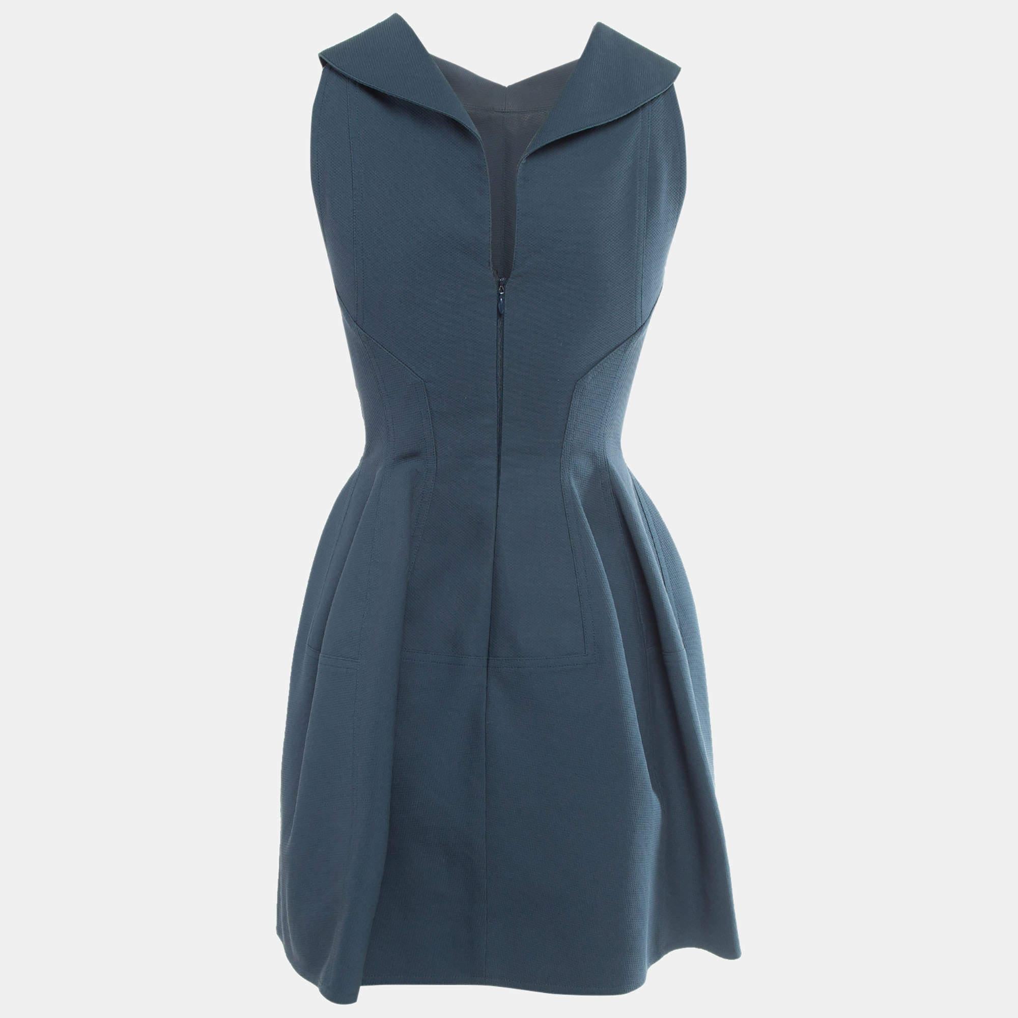 The Alaïa dress features a playful silhouette with intricate collar detailing. Crafted from premium cotton it offers a soft breathable feel perfect for warm days. The flared skirt adds a feminine touch while the textured fabric provides subtle