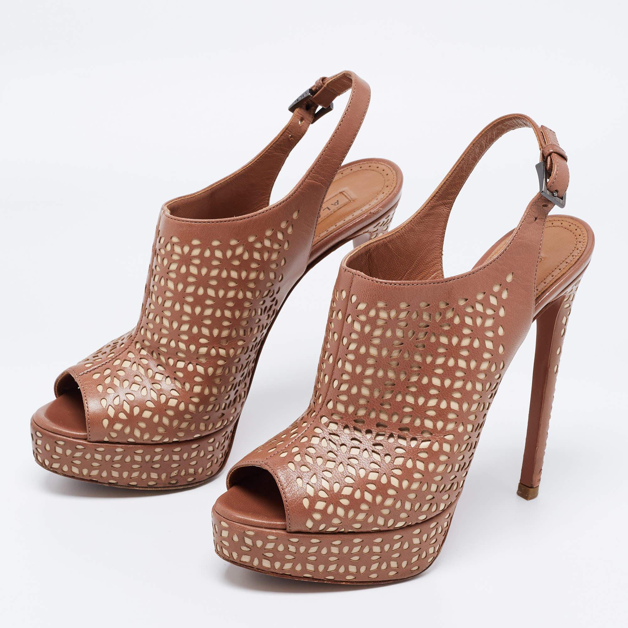 Lend an uber-chic appeal to your ensemble when you wear these stunning Alaia sandals. Crafted from leather in pretty hues, they feature peep toes and a cutout design all over. They are set on towering heels and are complete with buckle closures at