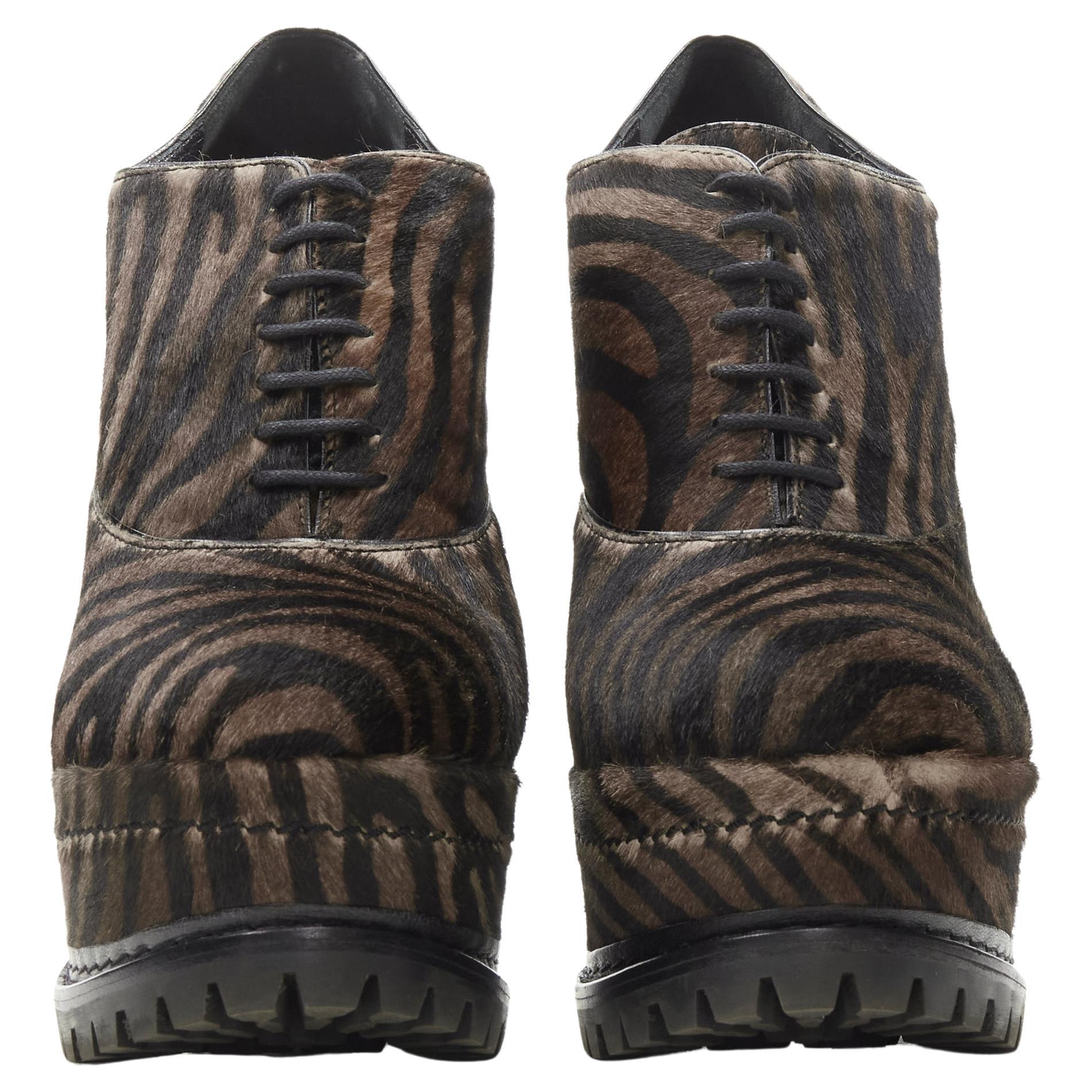 ALAIA brown black zebra stripe fur leather truck sole ankle bootie EU36.5
Brand: Alaia
Designer: Azzedine Alaia
Material: Leather
Color: Brown
Pattern: Zebra
Extra Detail: Trucker rugged sole. Laced front.
Made in: Italy

CONDITION:
Condition: