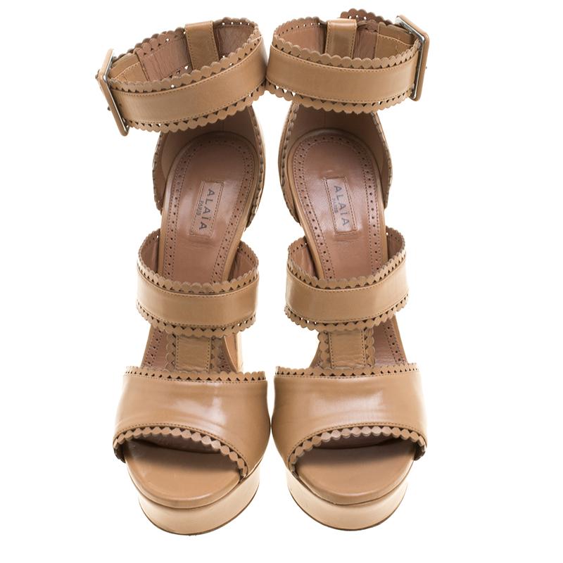 Embrace a chic style with this pair of sandals from the house of Alaia. Presented in a lush brown shade that can perfectly match your ensemble for the day, these platform heeled sandals make you stand out from the e crowd with their smart strap