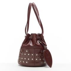 ALAIA burgundy red geometric silver studded drawstring mirror charm bucket bag