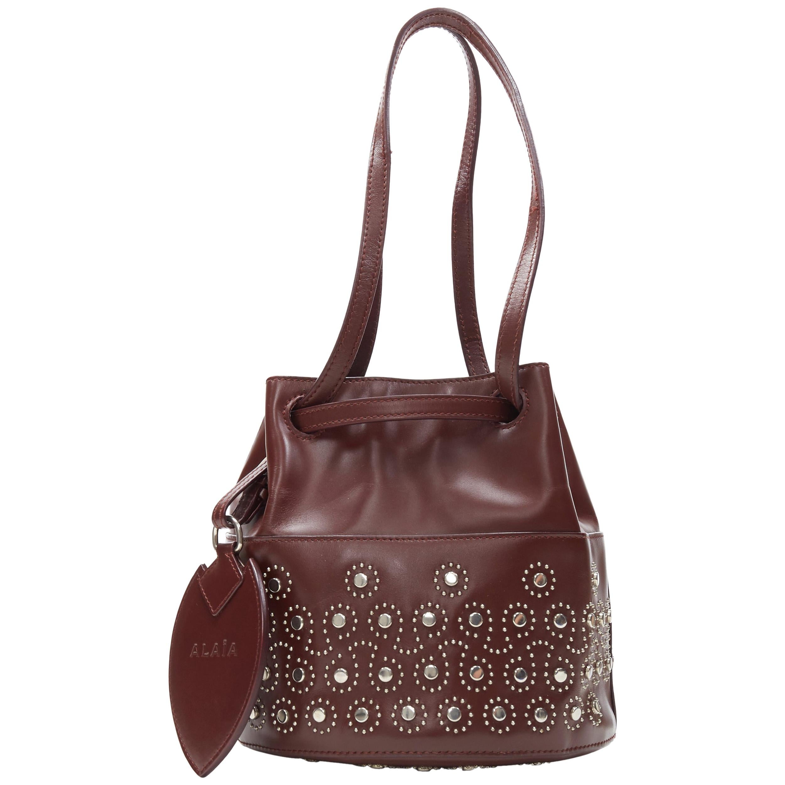 ALAIA burgundy red geometric silver studded drawstring mirror charm bucket bag
