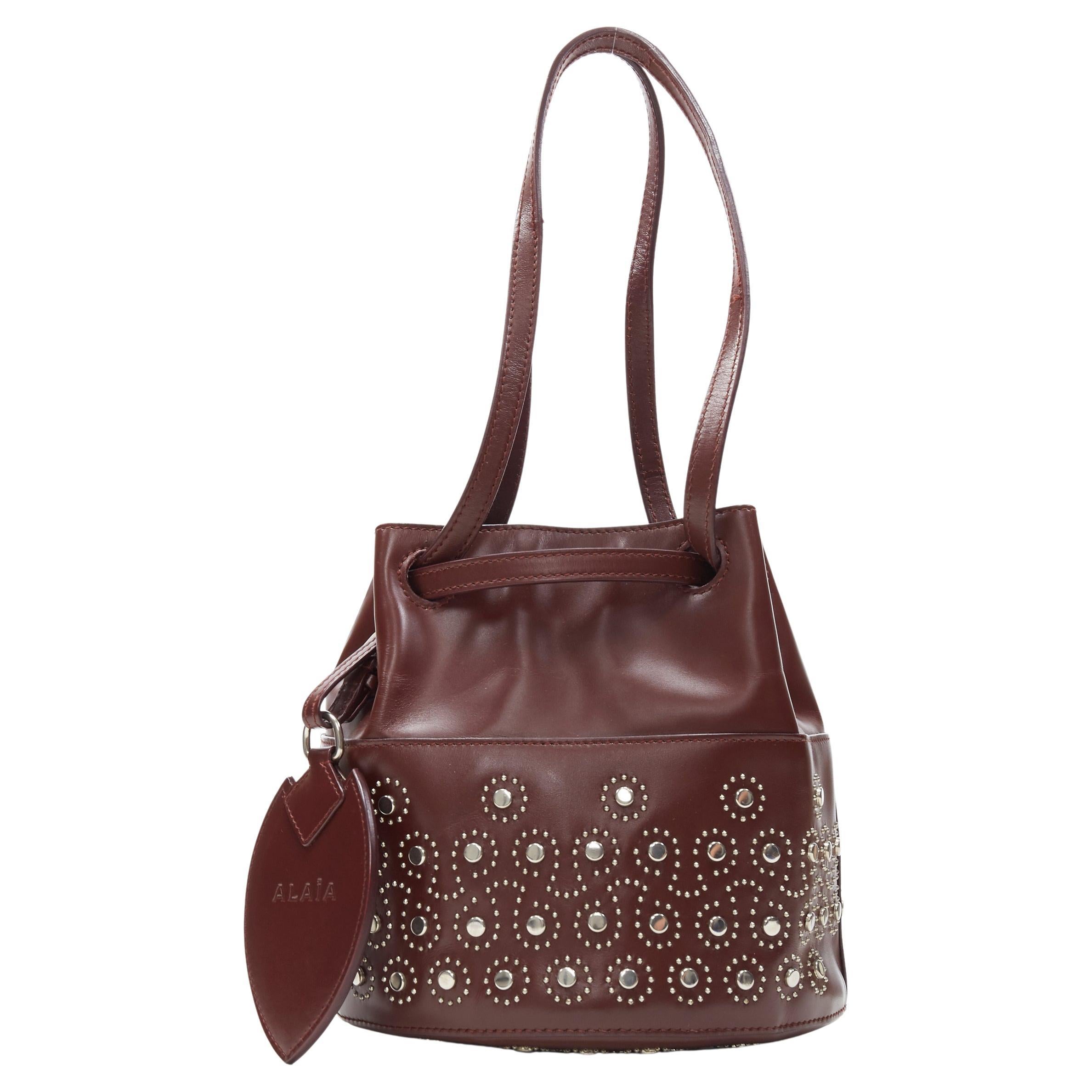 ALAIA burgundy red geometric silver studded drawstring mirror charm bucket bag For Sale