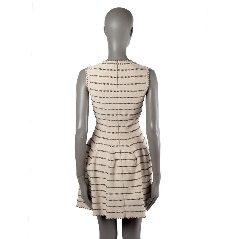 Alaia knit pleated dress in creme and black viscose (70%), nylon (18%), polyester (7%) and elastane (5%). Opens with zipper on the back. Unlined. Has been worn and is in excellent condition.

Tag Size 38
Size S
Bust 74cm (28.9in) to 82cm