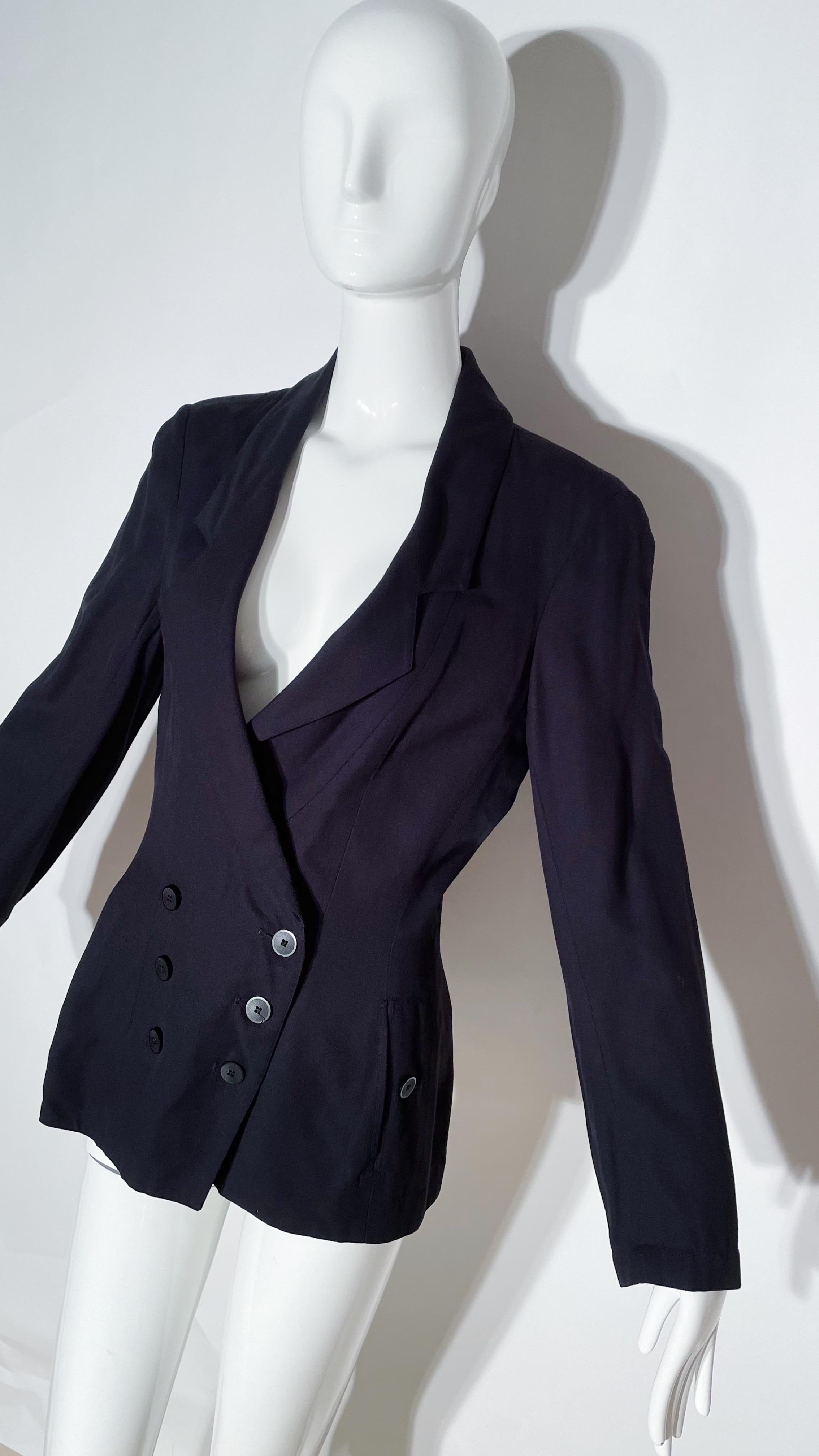 Black double breasted blazer. Collared. Fitted style. Button closures. Front pockets. Viscose.
*Condition: Excellent vintage condition. No visible Flaws.

Measurements Taken Laying Flat (inches)—
Shoulder to Shoulder: 16 in.
Sleeve Length: 24