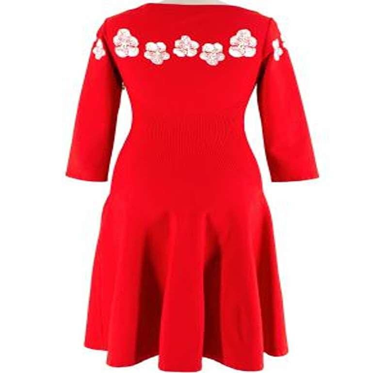 Alaia Floral Red Stretch Knit Skater Dress

- Mid weight
- fine stretch knit body
- White jacquard floral pattern 
- Ribbed, fitted waist 
- Skater skirt 
- 3/4 sleeves 
- Crew neckline
- Side concealed zip fastening 

Materials:
80% Viscose
20%