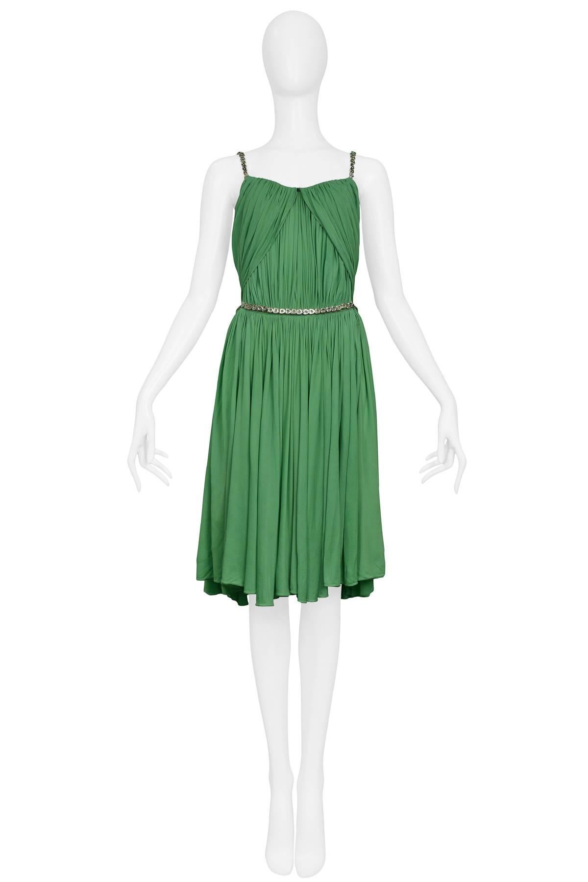 Vintage Azzedine Alaia green goddess mini dress with silver hardware at straps, side cutouts, and metal waist belt. 

