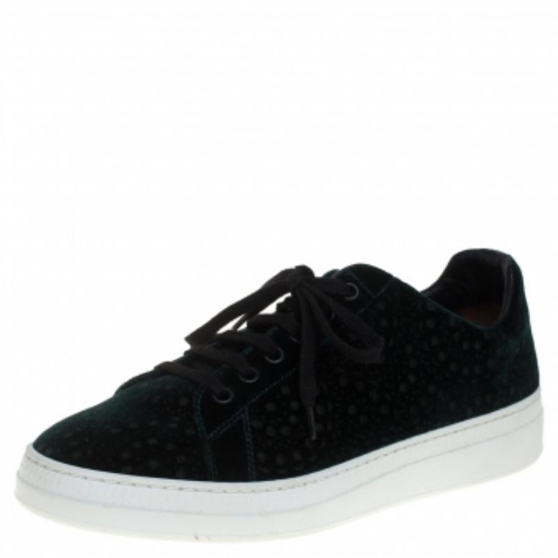 A statement in style and comfort, these shoes from Alaia come in a green velvet body with a lace-up front, laser-cut design all over the exterior, and a low-top silhouette. It also features interior leather lining, a lightly cushioned insole, and