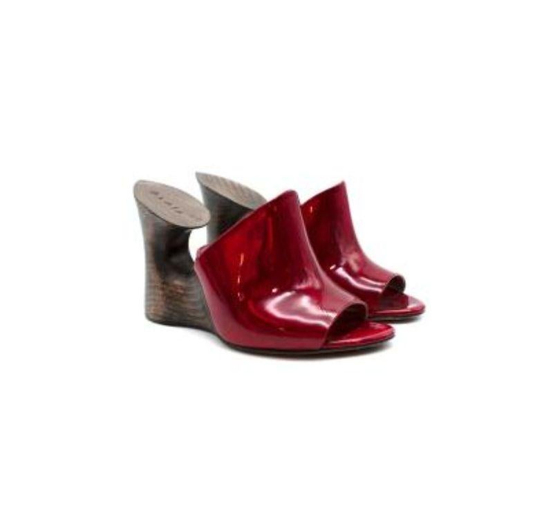 Alaia Iridescent Red Sculpture Mules

- Smooth wood and patent leather 
- Iridescent red strap 
- Wooden block heel
- Part lined with nude leather
- Slip on

Materials:
Wood
Patent leather 

Made in Italy 

9.5/10 very good condition. Please use