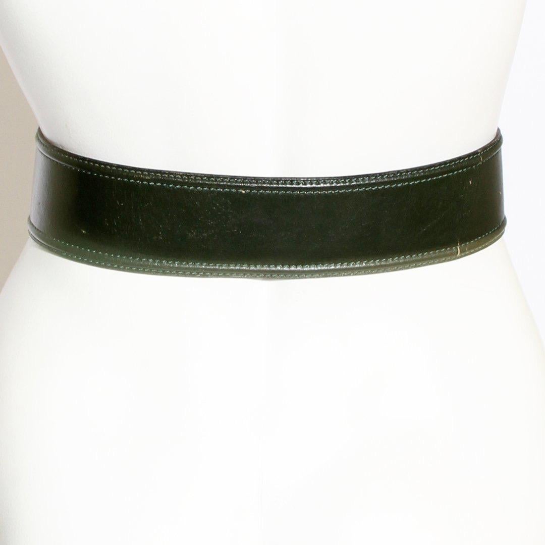 Belt by Azzedine Alaïa
Circa 1980
Forest Green
Leather belt
Gold-tone hardware 
Made in France
Condition: Decent. Leather a bit worn. Leather peeling. Water marks. 

Size/Measurements: (approximate)
31