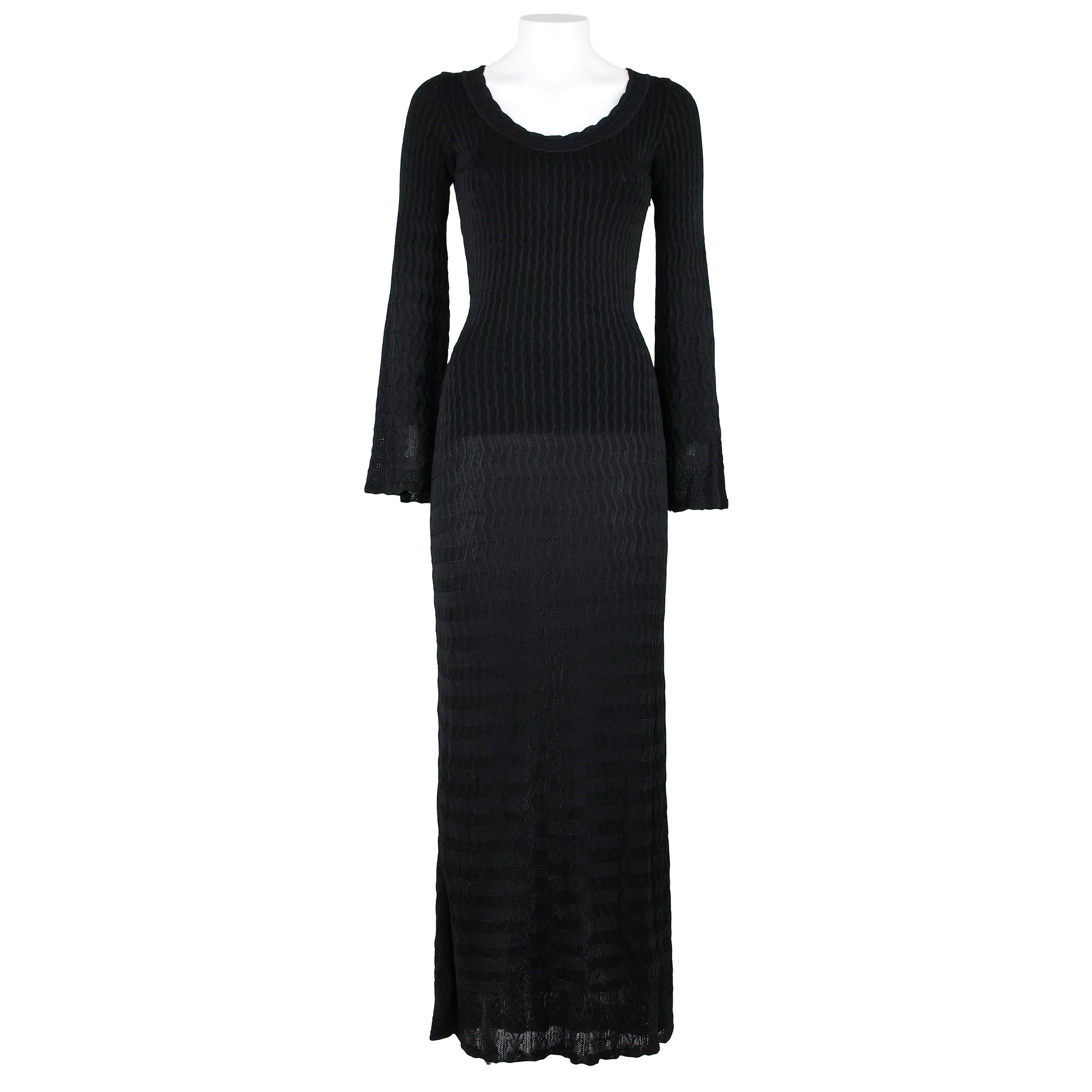 Azzedine Alaia black knit maxi stretch dress, long sleeves flared cuffs and flare skirt, zipper closure. Can be worn off shoulder or dancer neckline. Size 38 FR.

Measurements:
Shoulders 31cm
Chest 34cm
Waist 29cm
Length 147cm