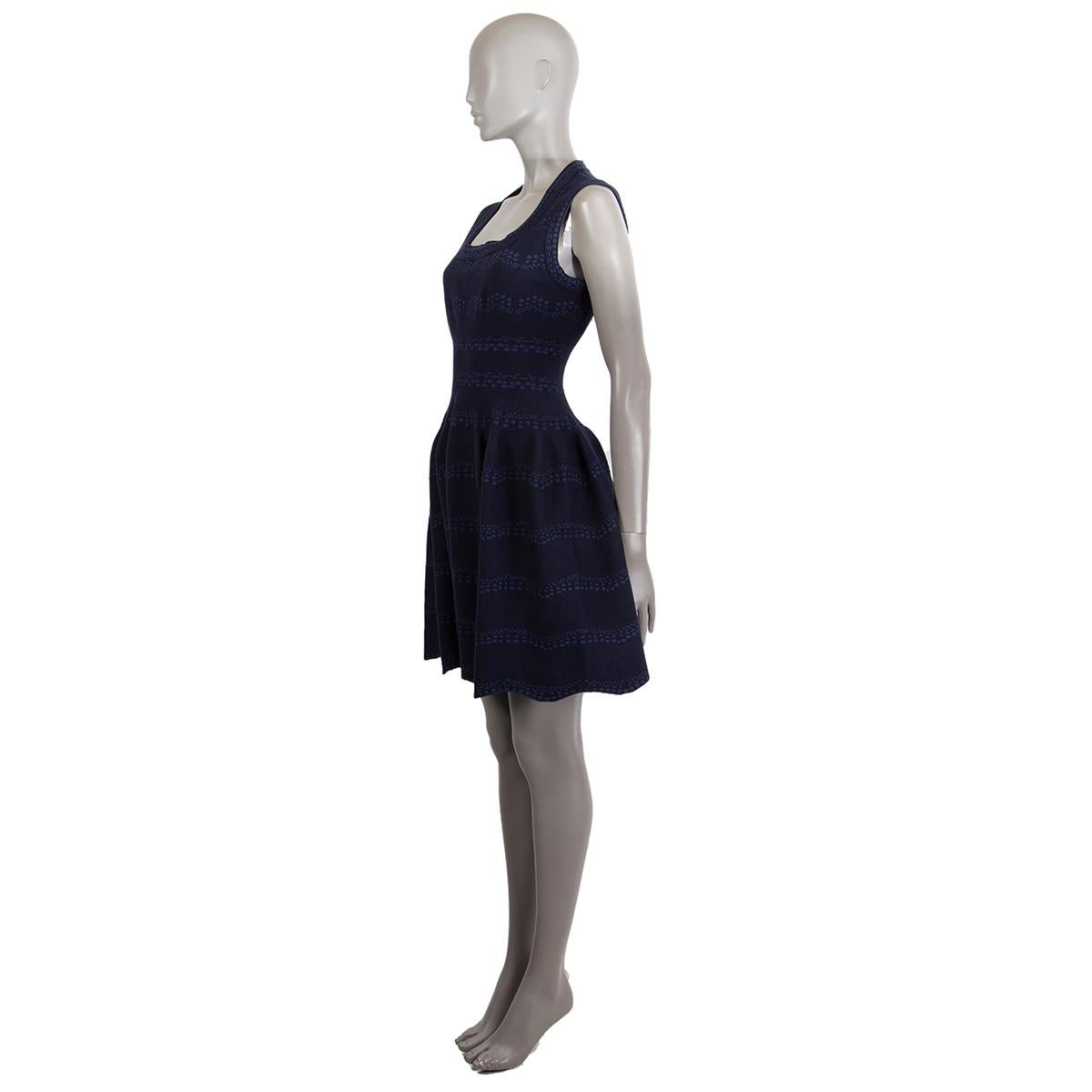 Alaïa flared jacquard knit sleeve-less scoop-neck dress in midnight blue and navy wool (43%), viscose (37%), polyamide (7%) and elastane (3%). Opens with zipper on the back. Unlined. Has been worn and is in excellent condition.

Tag Size 40
Size