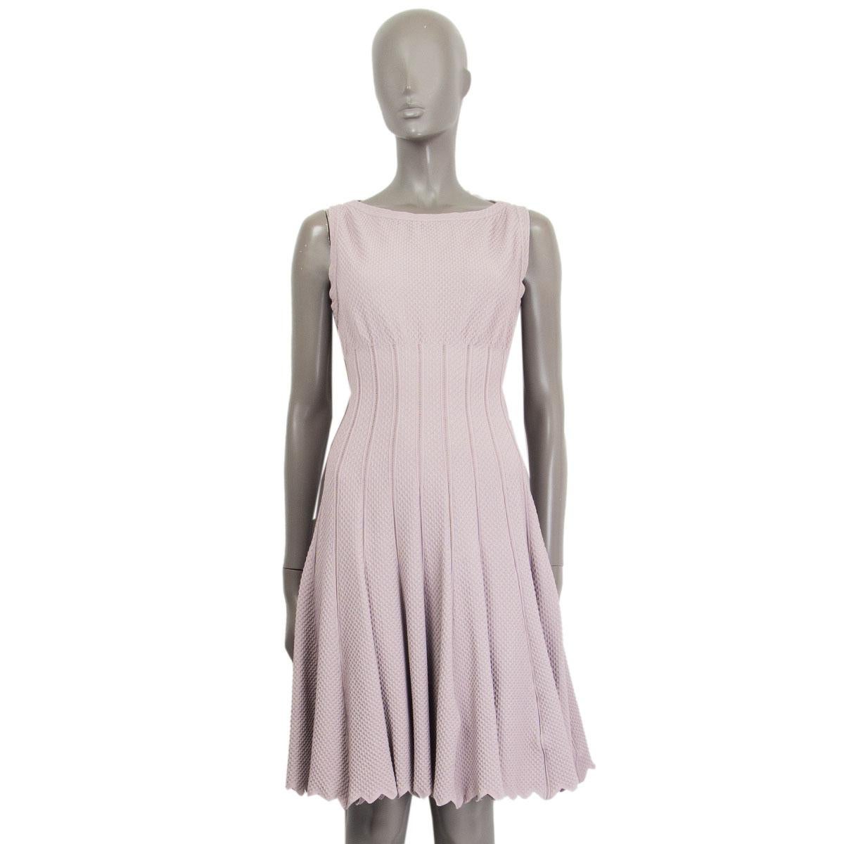 Alaïa sleeveless flared dress in pale lilac viscose (75%), polyester (15%) and polyamide (10%) featuring scalloped hemline. Opens with a zipper on the back. Has been worn and is in excellent condition. 

Tag Size 42
Size L
Shoulder Width35cm