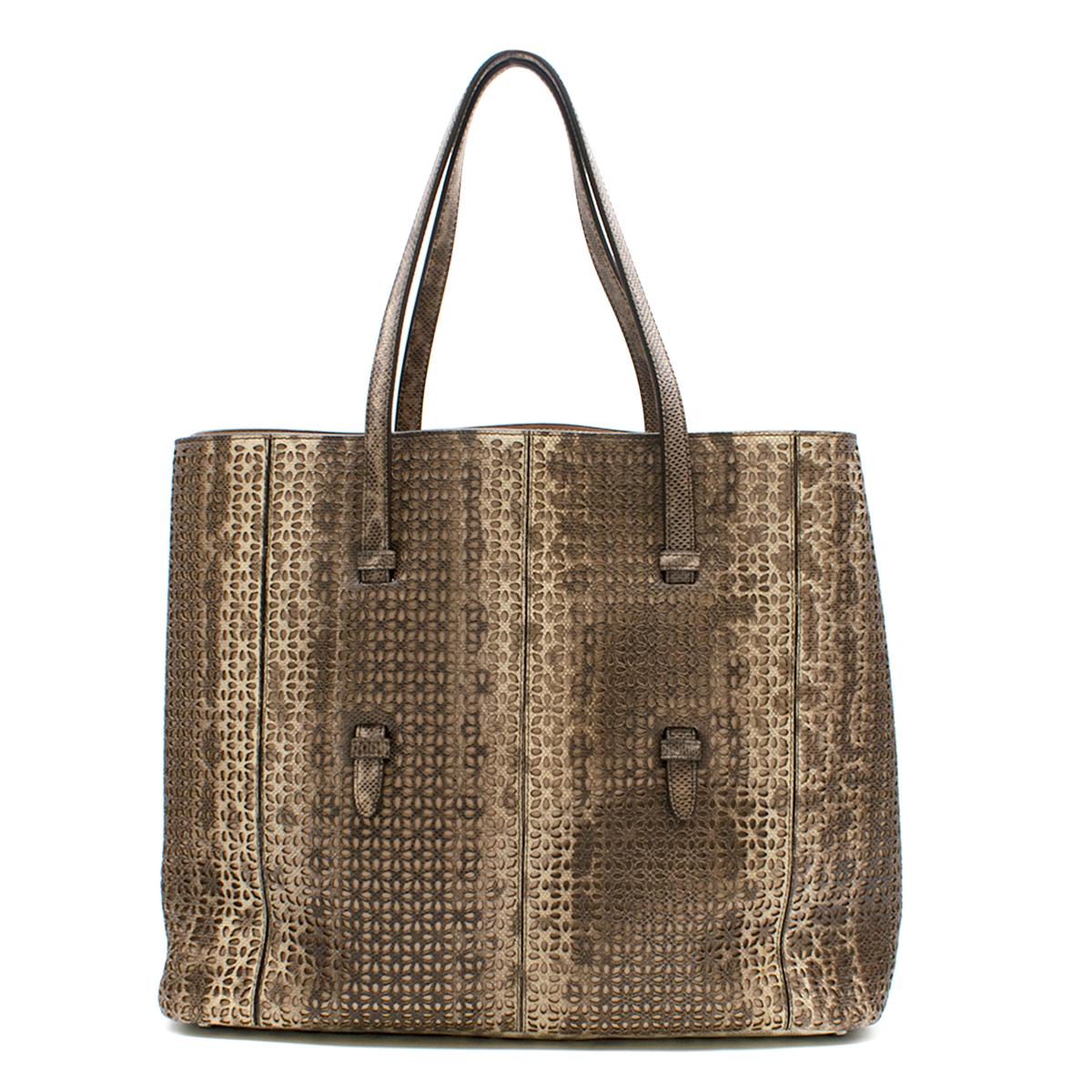 Alaia Watersnake Skin Tote Bag 

- Watersnake Skin Tote Bag 
- Laser Cut perforated 
- Beige leather lining 
- Silver toned feet 
- Internal leather pouch and mirror attached 
- This item comes with a dust bag. 
- Water Snakeskin

Please note, these