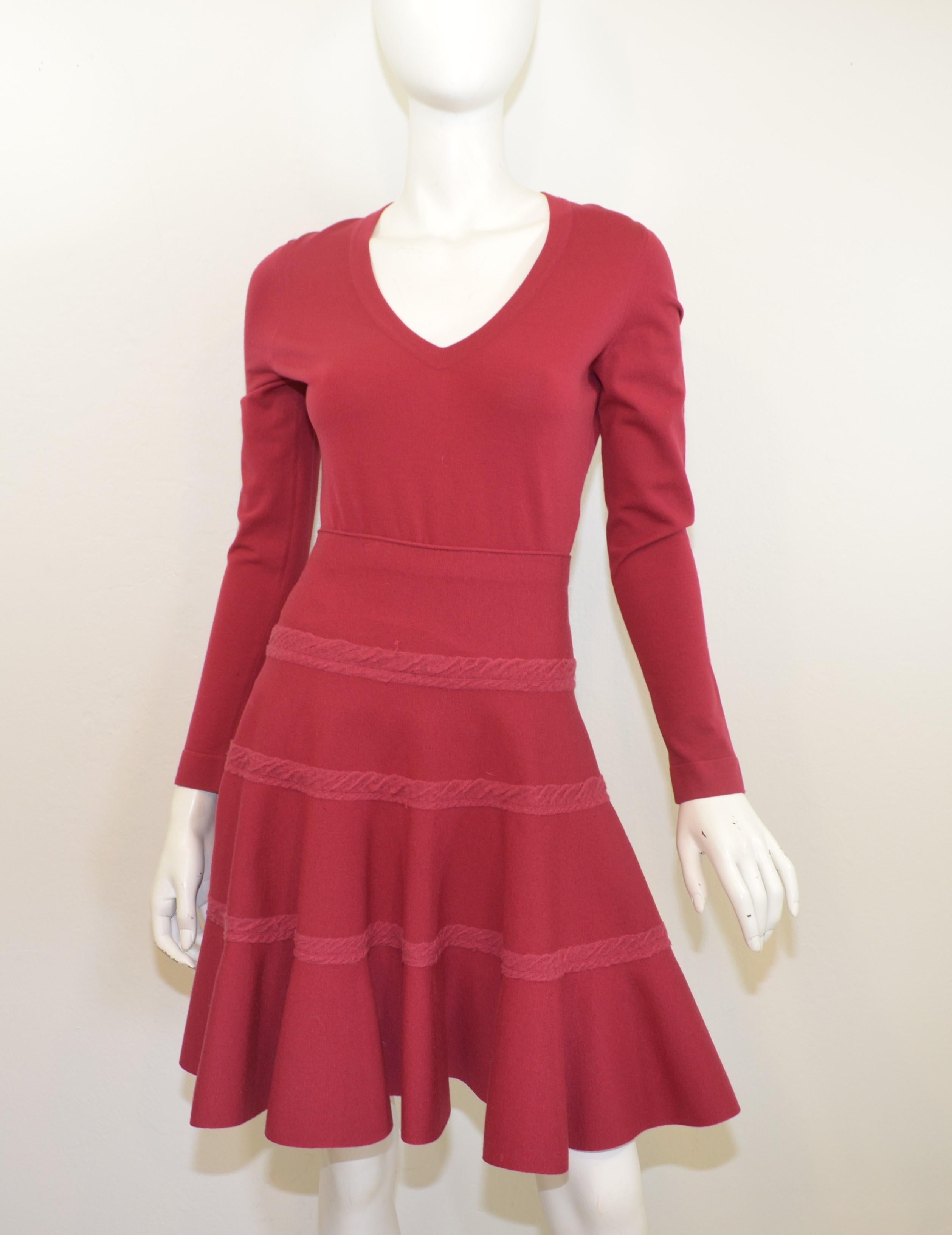 Alaia skirt set is featured in a raspberry, maroon colored knit. Top has a v-neckline and skirt has a flared silhouette (fit & flare style). Set is labeled size 42, and composed with a wool, polyester, and nylon blend. Made in