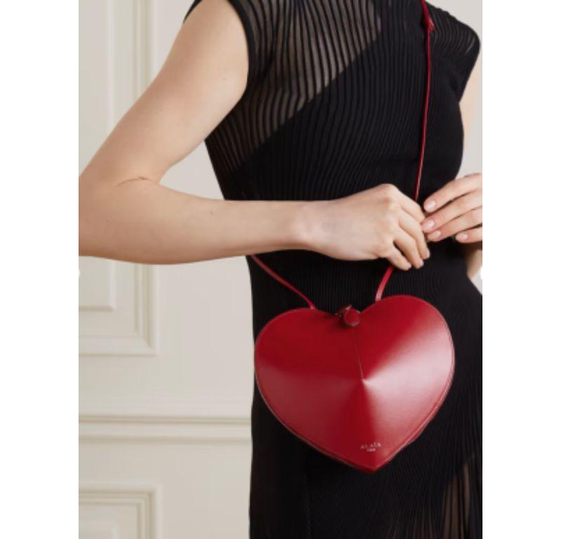 Alaia Red Leather Le Coeur Heart Shaped Bag

- Gorgeous red leather bag in the shape of a heart
- Perfect for date night or as a gift
- Long strap
- Silver-toned hardware
- Zipper fastening
- 'Alaia Paris' printed in silver on front

Material
Calf