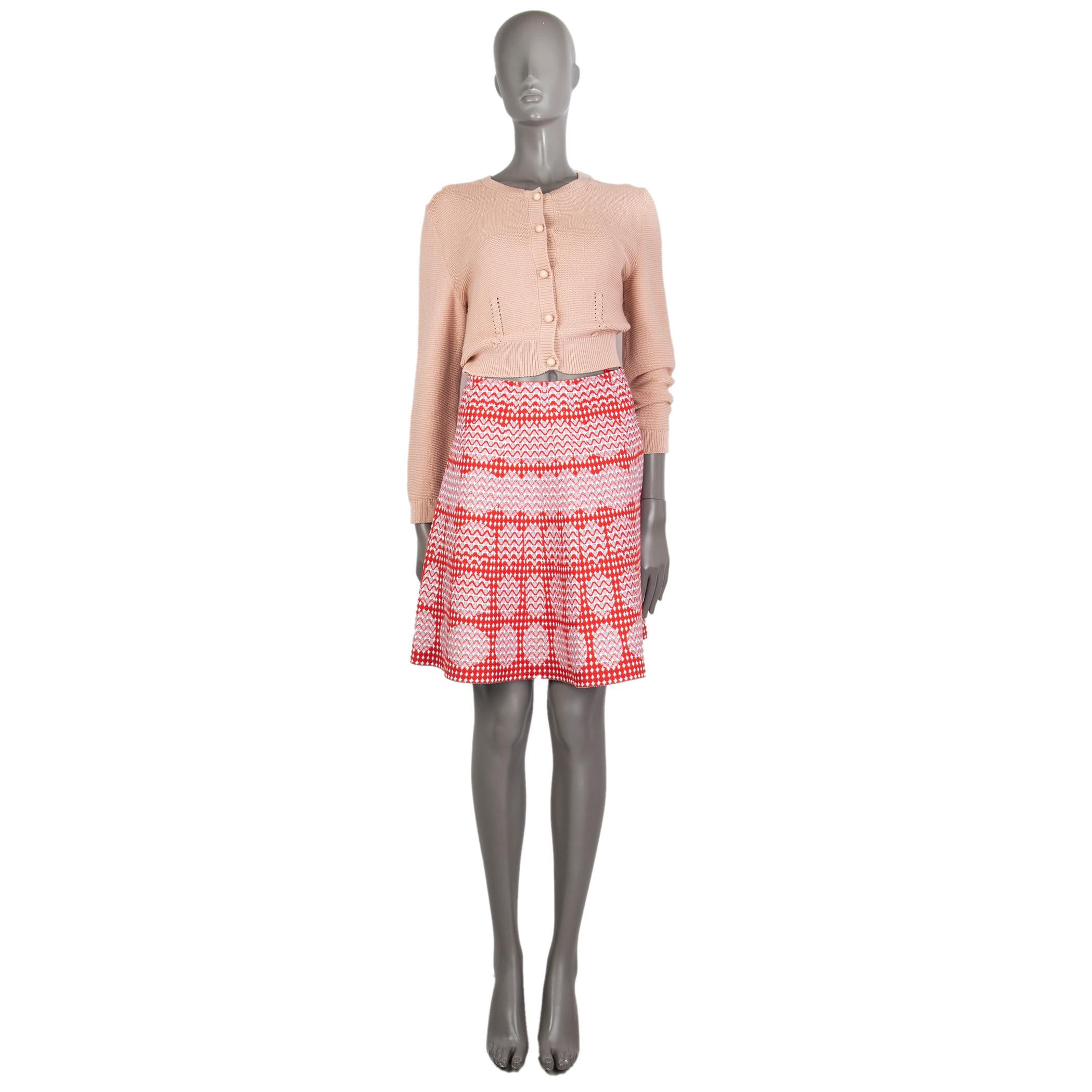 Alaia optic jacquard knit flared skirt in red, rose, white, and malachite viscose (80%), polyester (12%), nylon (6%), and elastane (2%). Unlined. Closes with inside hook and invisible zipper on the back. Has been worn and is in excellent condition.