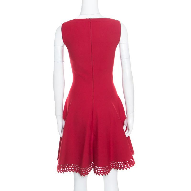 How lovely is this mini dress from Alaia! The ruby red creation is made of a viscose blend and features a flared silhouette. It flaunts a V-neckline and a laser cut bottom hem detailing that looks amazing. It comes equipped with a concealed zip
