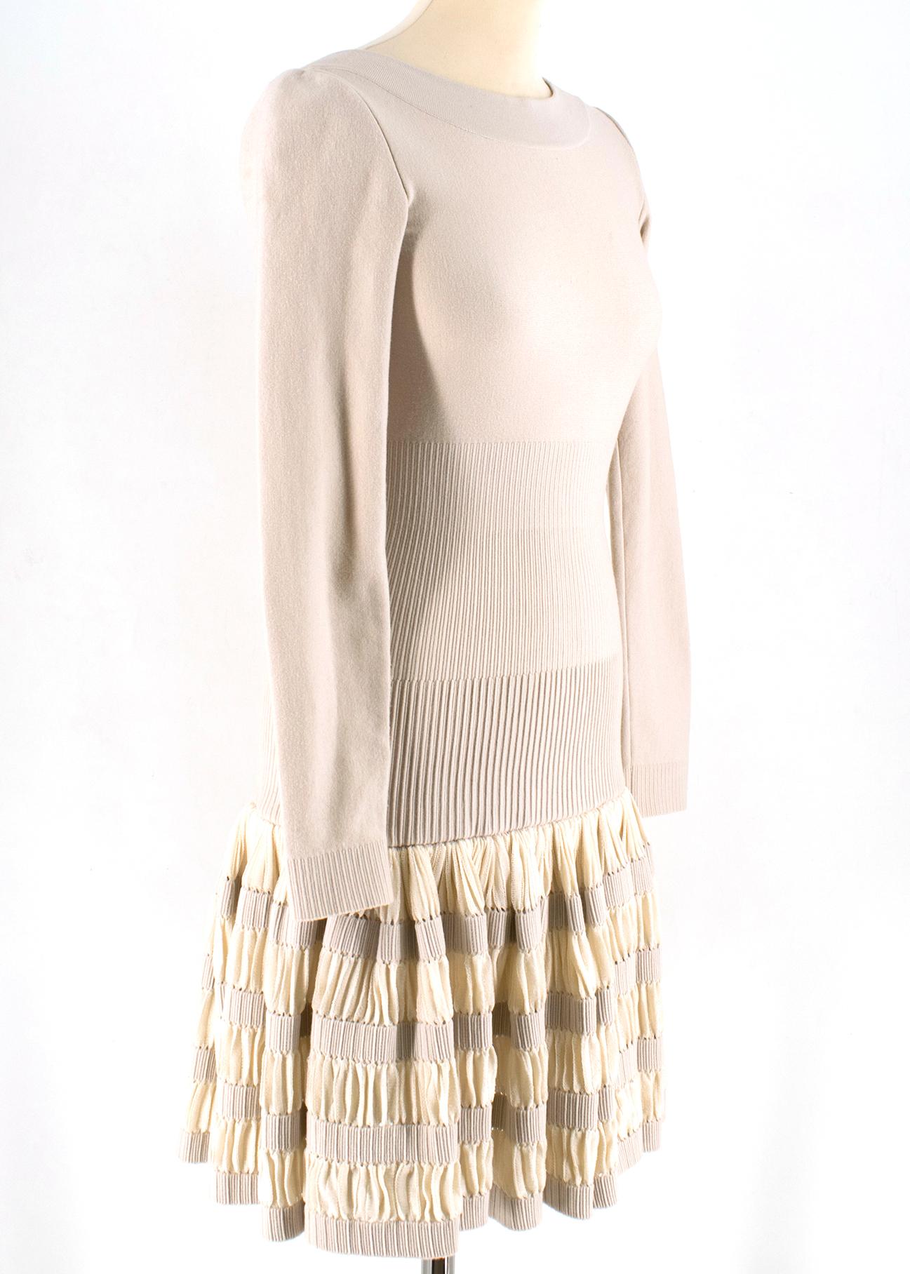 Alaia Beige Wool blend Knit Dress

- beige wool blend dress
- boat neckline
- v back
- unlined
- zip fastening to the back
- pleated base
- above the knee length 

Please note, these items are pre-owned and may show some signs of storage, even when