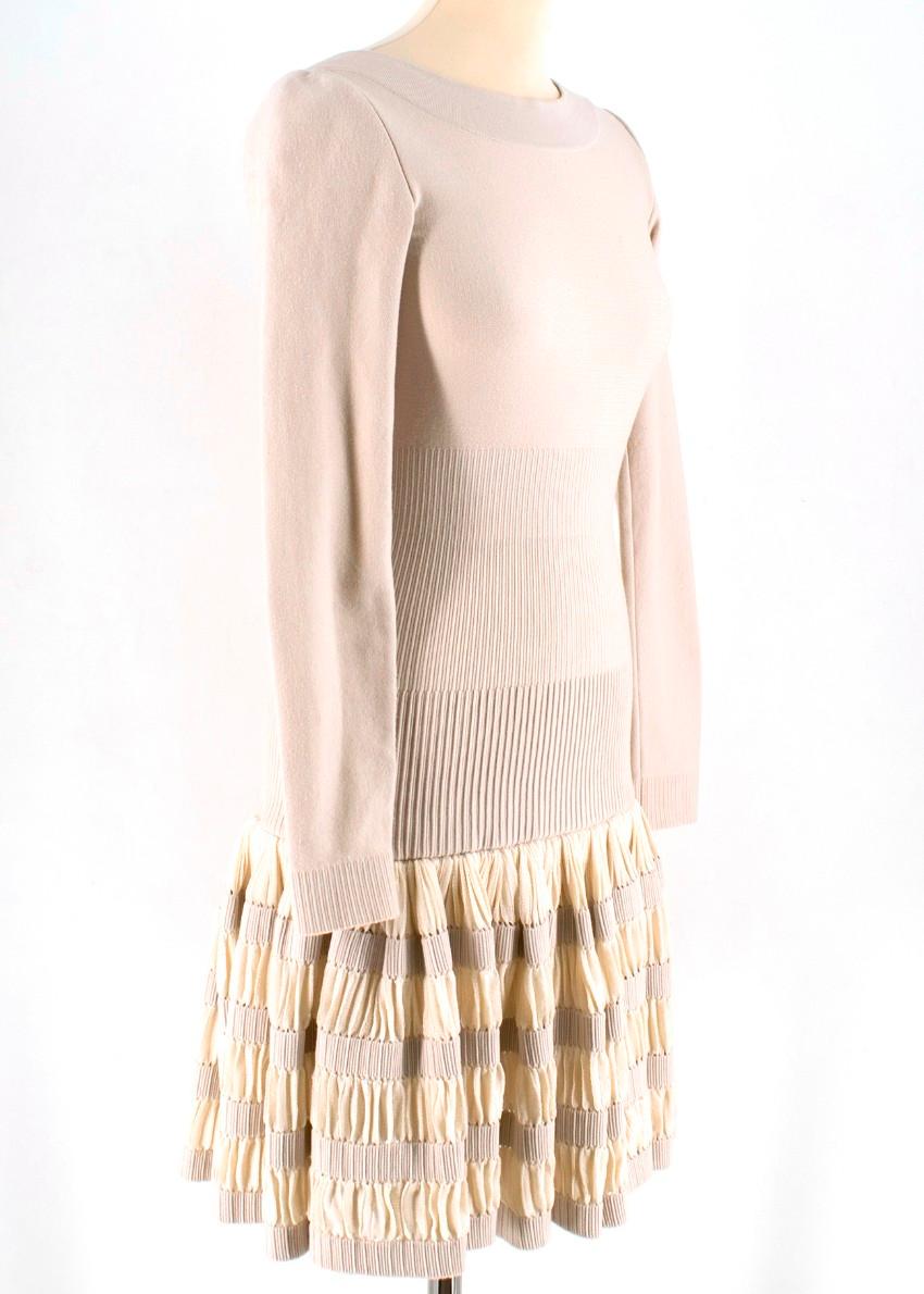 Alaia Beige Wool blend Knit Dress

- beige wool-blend dress
- boat neckline
- v back
- unlined
- zip fastening to the back
- pleated base
- above the knee length 

Please note, these items are pre-owned and may show some signs of storage, even when