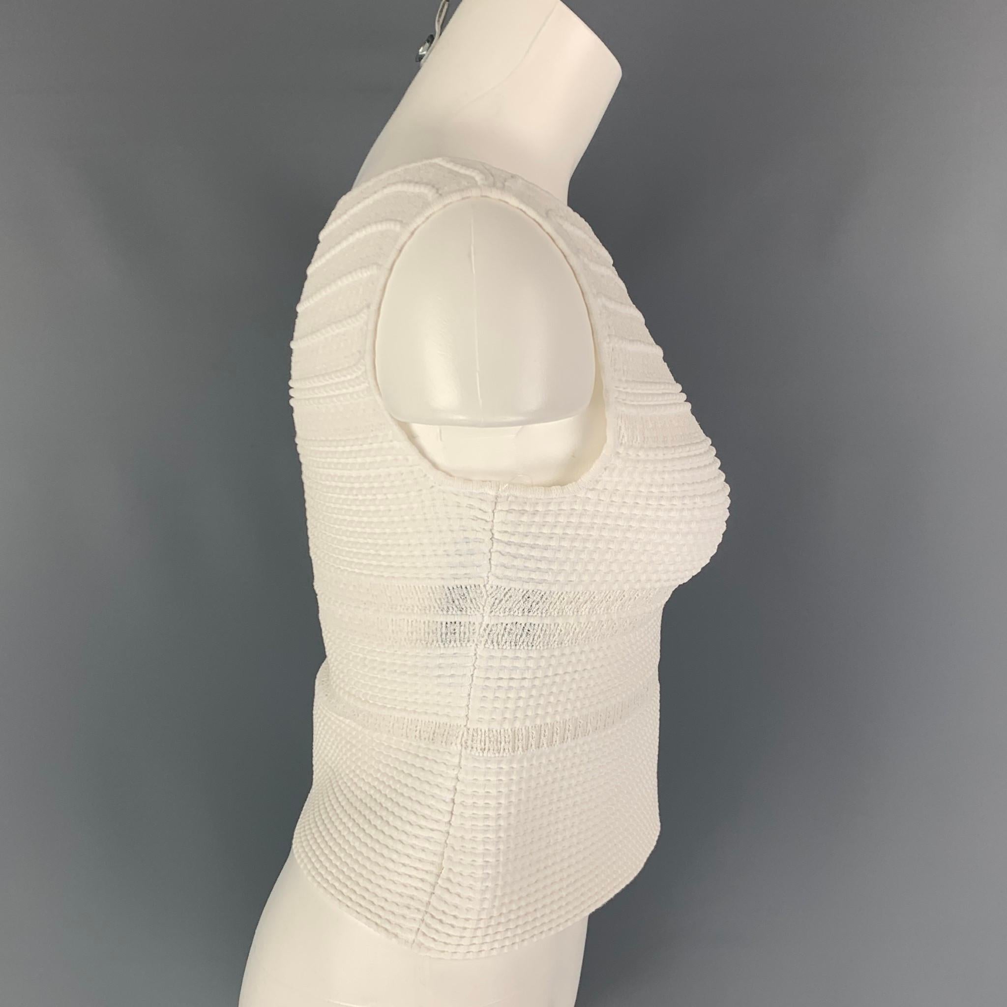 ALAIA dress top comes in a white knitted textured stretch cotton blend featuring a sleeveless style and a side zipper closure. Made in Italy. 

Very Good Pre-Owned Condition.
Marked: 42

Measurements:

Shoulder: 13 in.
Bust: 30 in.
Length: 16 in.