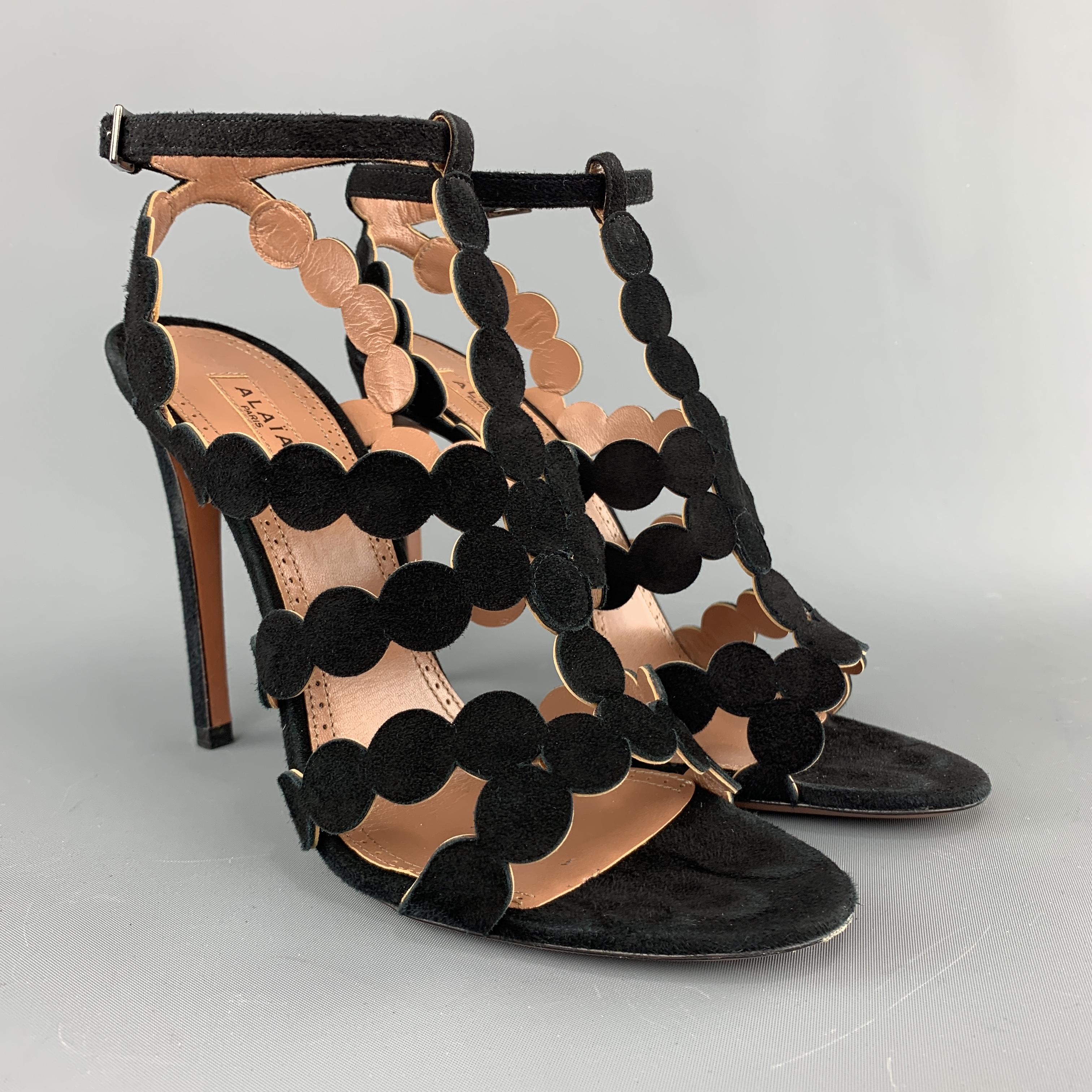ALAIA sandals come in black suede with laser cut round straps, ankle strap, and T strap front. Made in Italy.

Excellent Pre-Owned Condition.
Marked: 38

Measurements:

Heel: 4.75 in. 