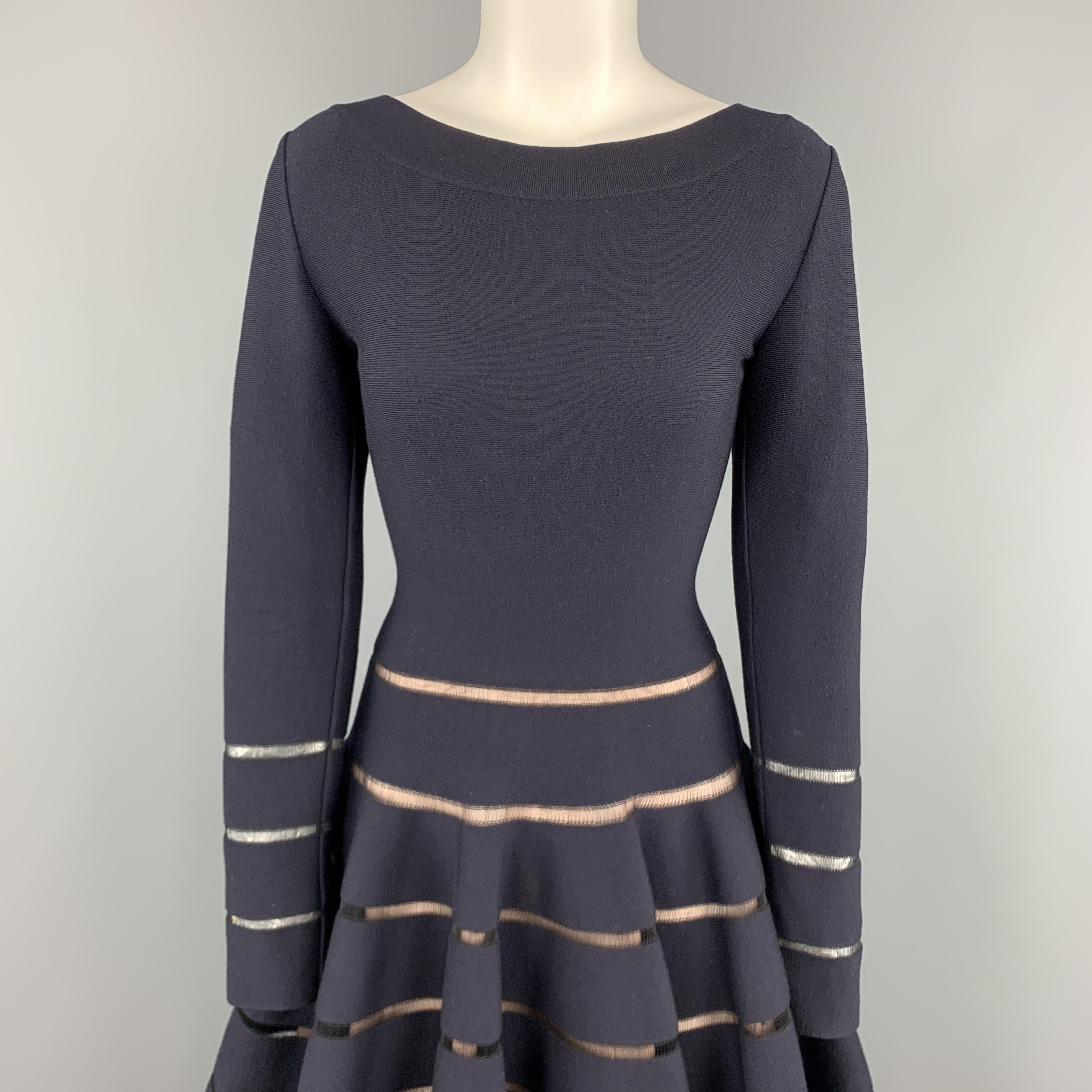 ALAIA fit flair dress come sin navy stretch wool knit with a boat neck, long sleeves, low V back, ruffled flair skirt, and sheer stripes. Made in Italy.

Very Good Pre-Owned Condition.
Marked: IT 44

Measurements:

Shoulder: 16 in.
Bust: 34