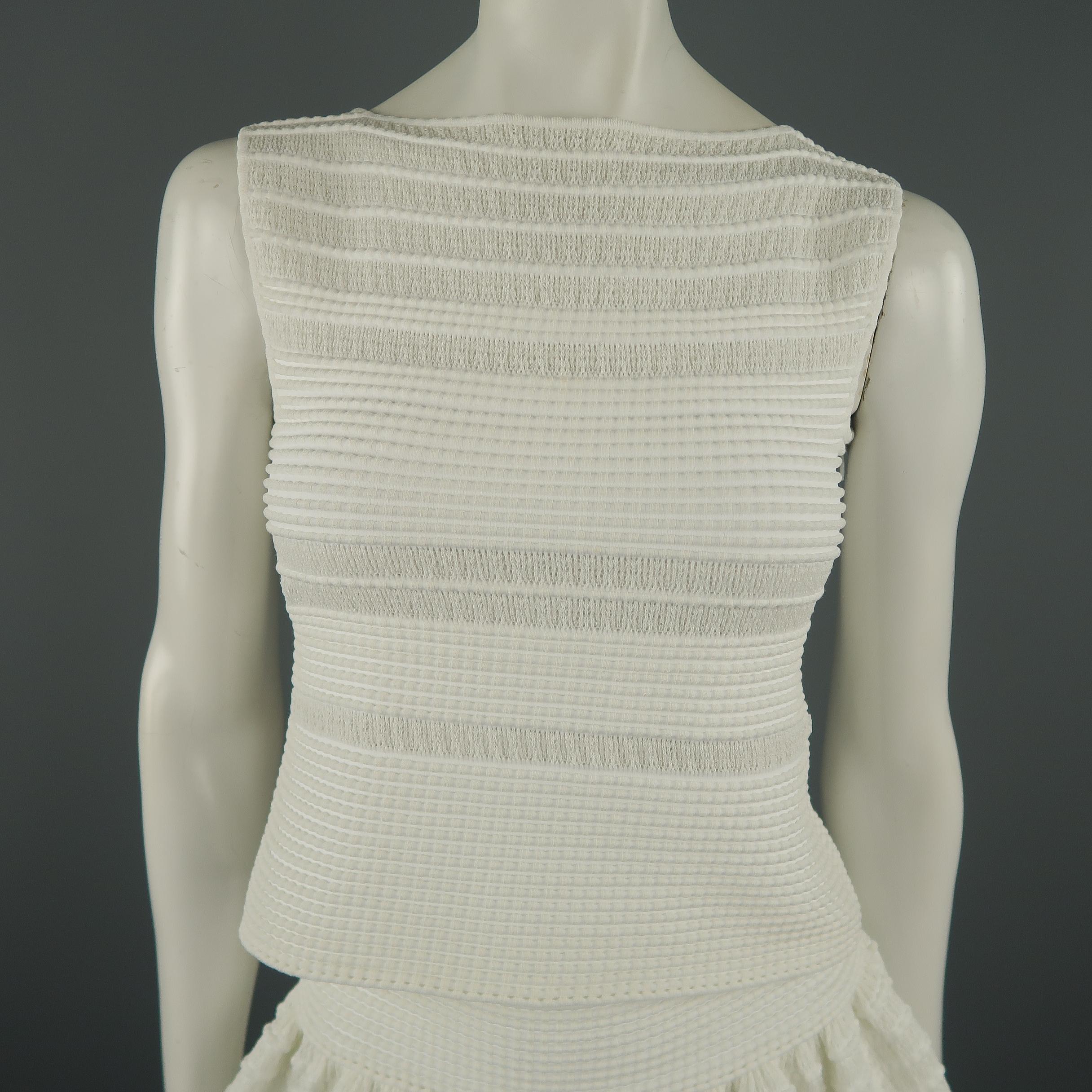 ALAIA ensemble comes in a stretch cotton textured mesh knit and includes a sleeveless boat neck top and matching ruffle A line skirt.  Made in Italy.
 
Excellent Pre-Owned Condition.
Marked: Top: FR 42 Skirt: IT 38
 
Measurements:
 
Top:
Shoulder: