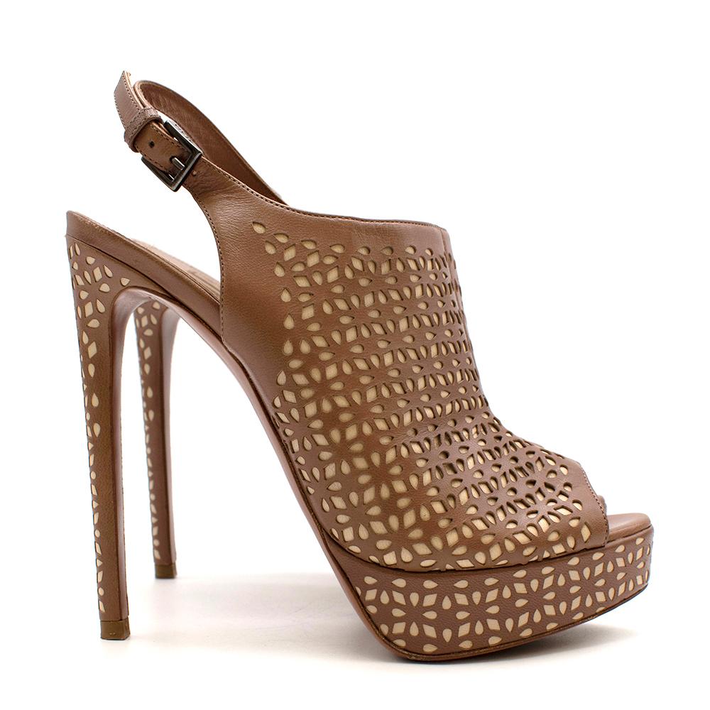 Alaia Tan Leather Laser-Cut Platform Slingback Pumps
- Soft leather material
- Stiletto heel
- Slingback strap with adjustable buckle
- Peep toe style
- Laser cut with beige leather detail

Materials: 
Main-leather 
Lining-leather 
Soles-leather