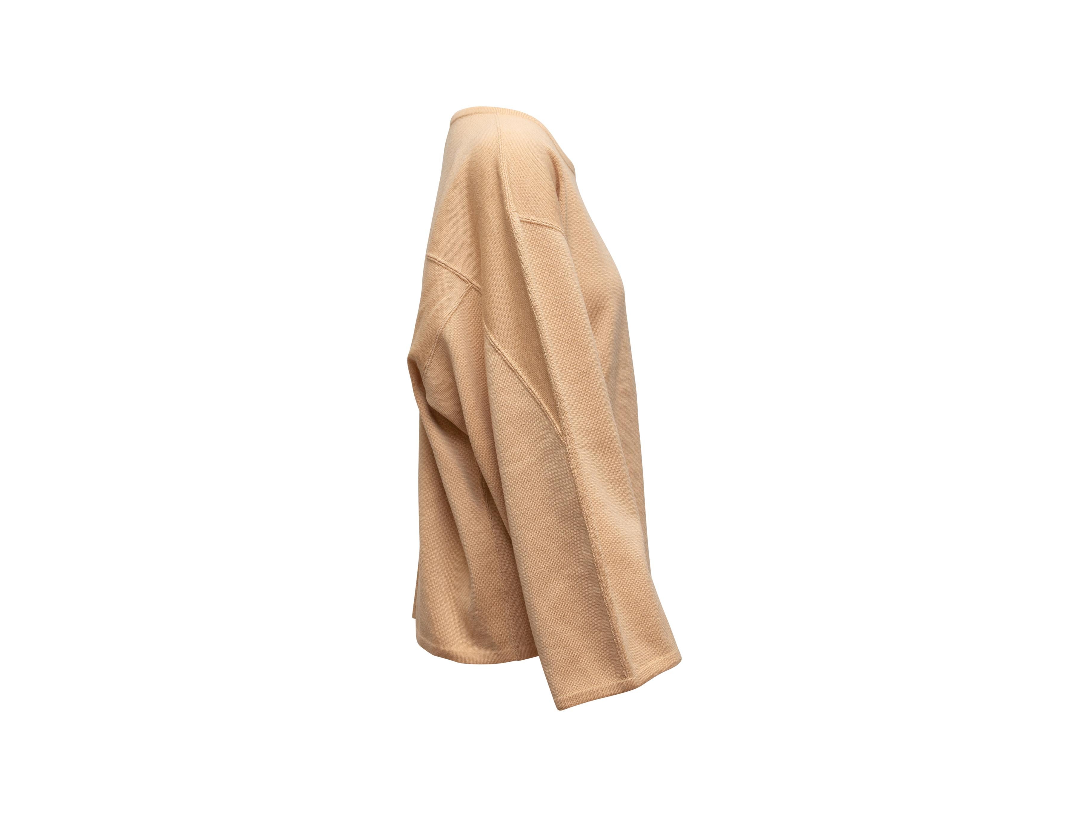 Product details: Vintage tan virgin wool sweater by Alaia. Crew neck. Wide long sleeves. 46