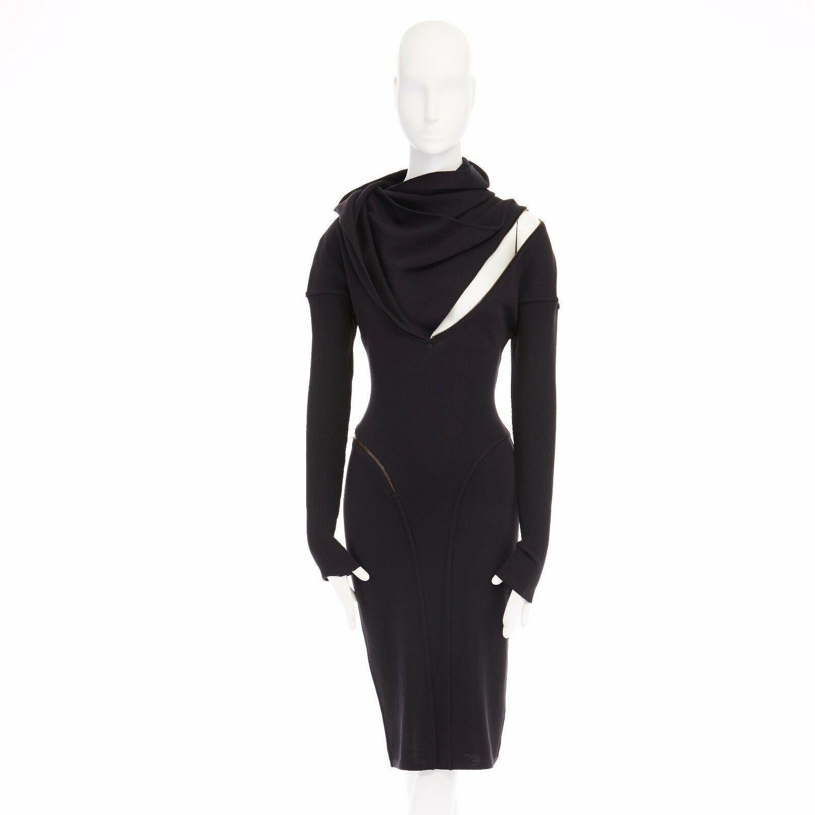 ALAIA Vintage 1987 black hooded spiral zip around fitted wool dress M

AZZEDINE ALAIA VINTAGE
FROM THE 1987 COLLECTION
AS EXHIBITED IN LA PALAIS GALLIERA
Black wool dress . Hooded . Draped neckline . Adjustable neckline with dual snap button detail