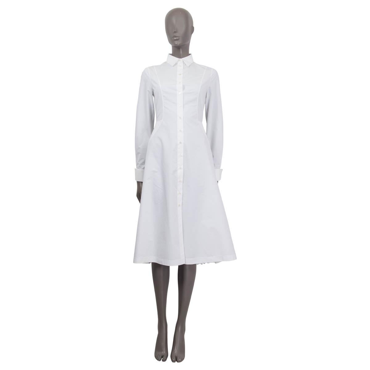 100% authentic Alaia a-line midi dress in white cotton (53%) and polyester (47%). Features buttoned cuffs, laser cut details and a waist belt at the back. Opens with fourteen buttons on the front. Unlined. Has been worn once and is in virtually new