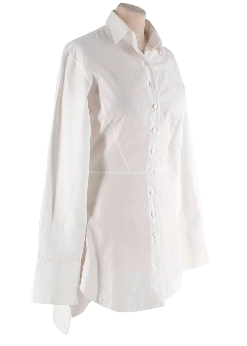 Alaia White Cotton Poplin Longline Shirt
 

 - Alaia take on the classic white shirt, rendered in a crisp cotton poplin, featuring classic collar, exaggerated cuff, and skirted back 
 - Button through, cinched waist, sculpted hemline
 - Style over a