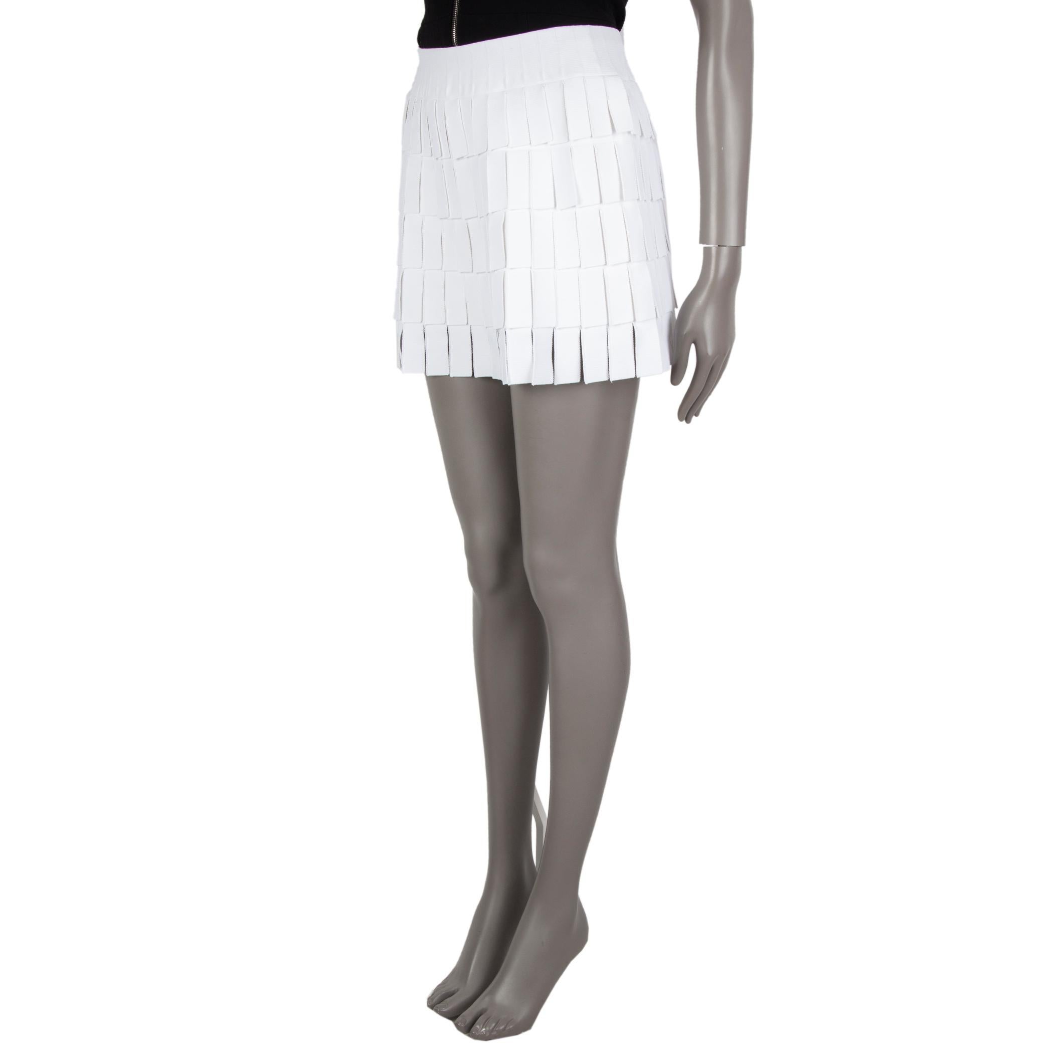 Alaia mini-skirt in white viscose (84%) polyester (10%) polyamide (4%) elastane (2%) with an elastic waistband layer of fringe to slip on. Lined with shorts viscose (66%) polyamide (16%) polyester (14%) elastane (4%).  Has been worn and is in