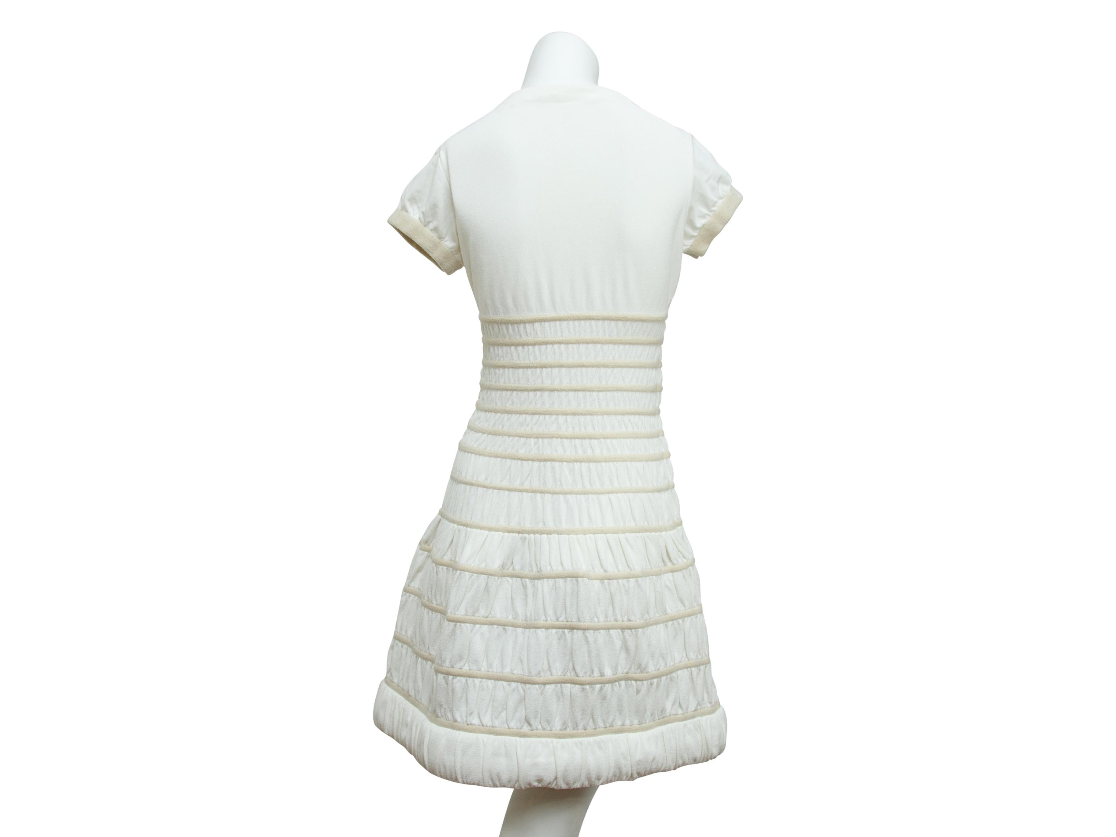 Product details:  White stretch-knit fit-and-flare dress by Alaia.  Crewneck.  Short sleeves.  Ribbed cuffs.  Pullover style.  29