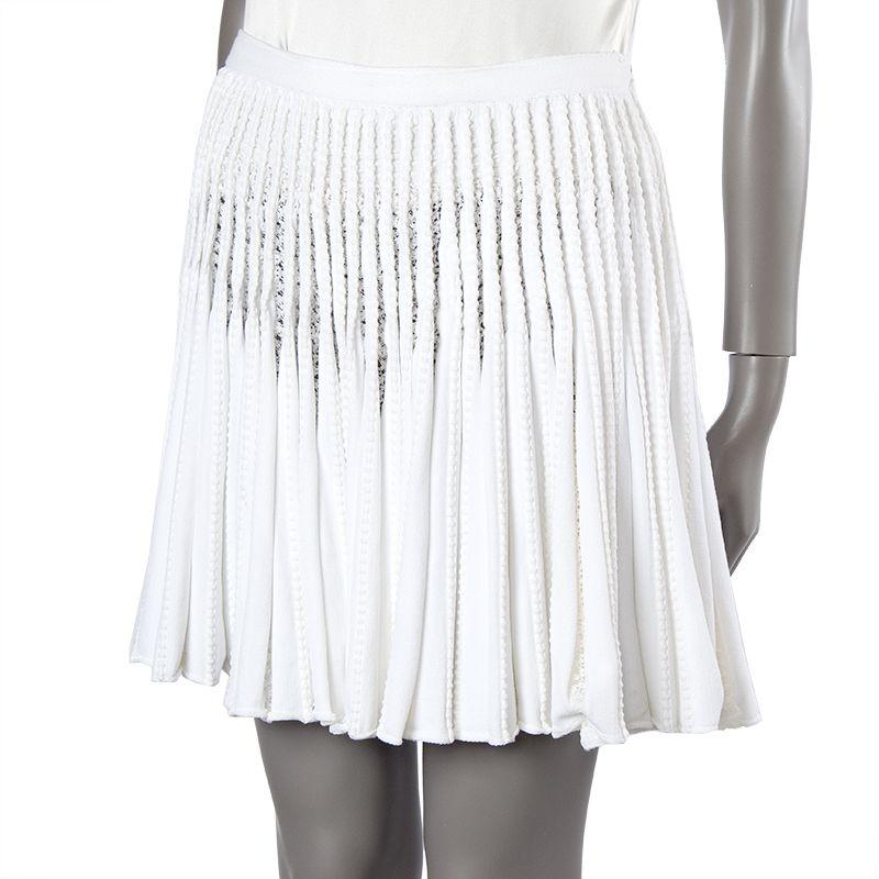 Alaia flared knit skirt in off-white viscose (50%), cotton (30%), nylon (10%), and polyester (10%). Closes with invisible side zipper and one off-white button. Unlined. Has been worn and is in excellent condition.

Tag Size L
Size L
Waist 74cm