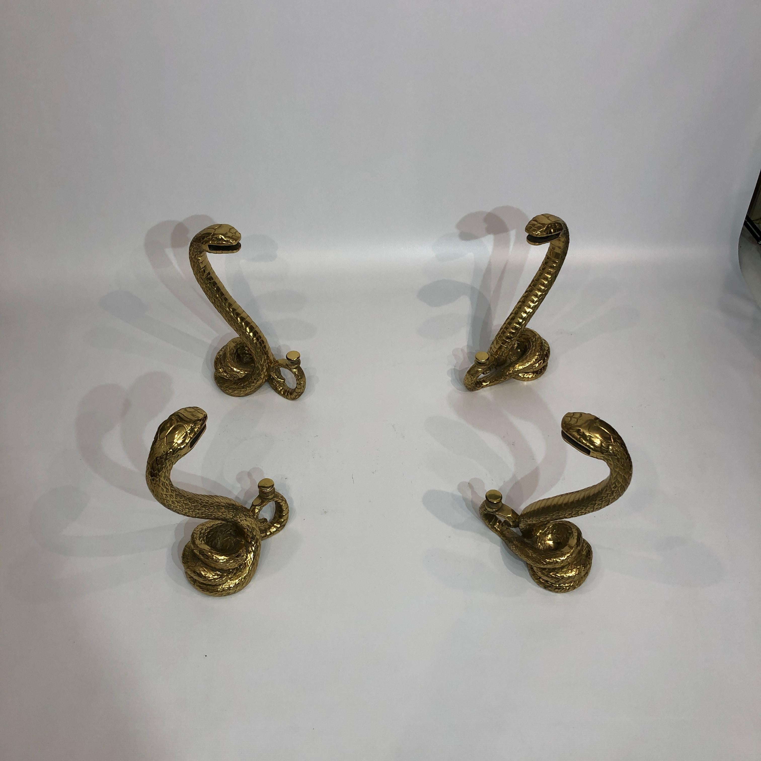This coffee table, very much in the manner of French designer Alain Chervet, consists of four individual brass snakes. Delicately moulded, the snakes are designed to hold two panes of glass –– one smaller sheet towards the bottom, and then one