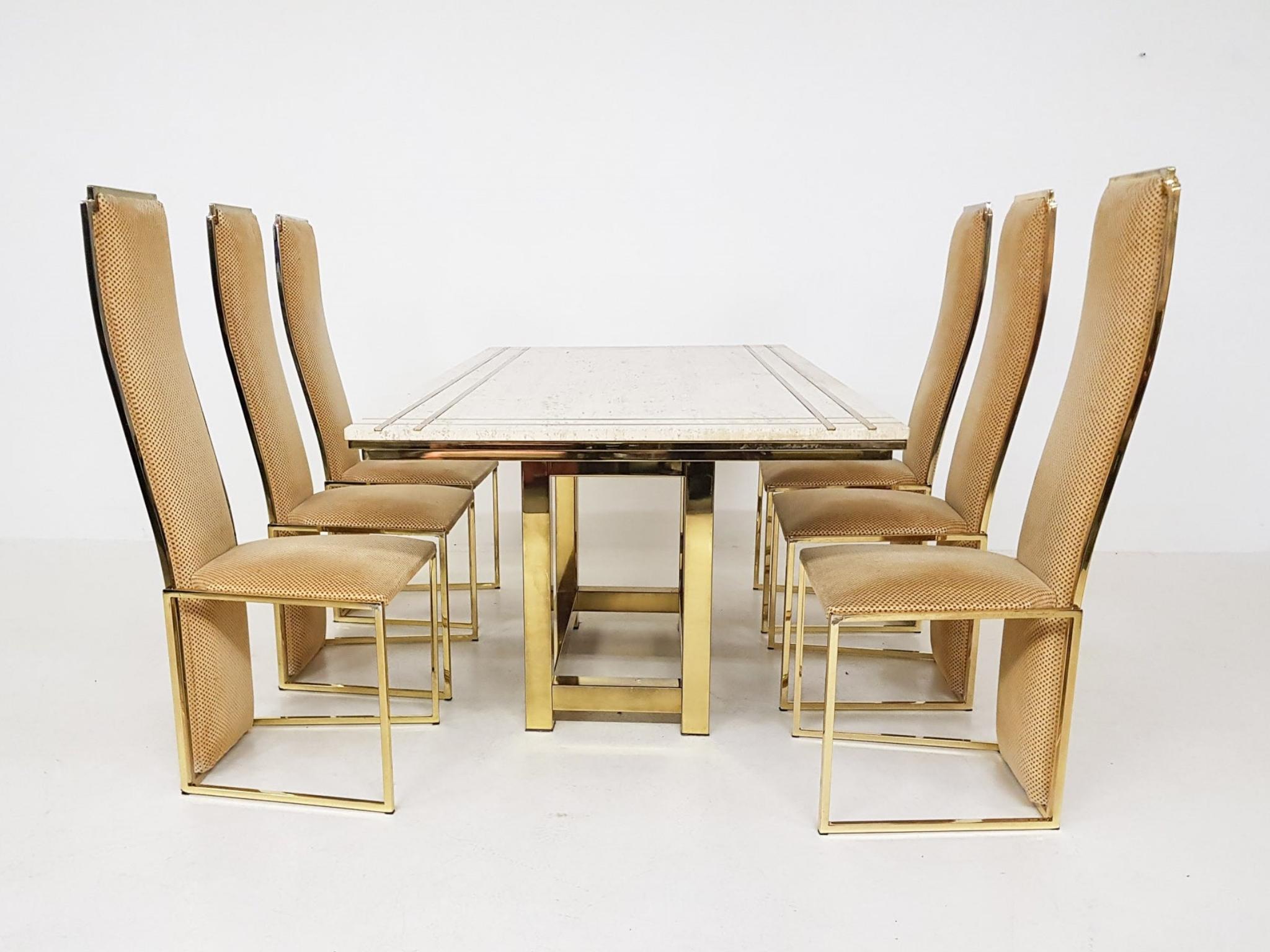 High-end travertine and gold-plated metal dining set by Alain Delon. Made and designed in France in the 1980s.

An impressive dining table made of the most beautiful travertine with a cross shaped brass inlay. The table rests on a gold-plated