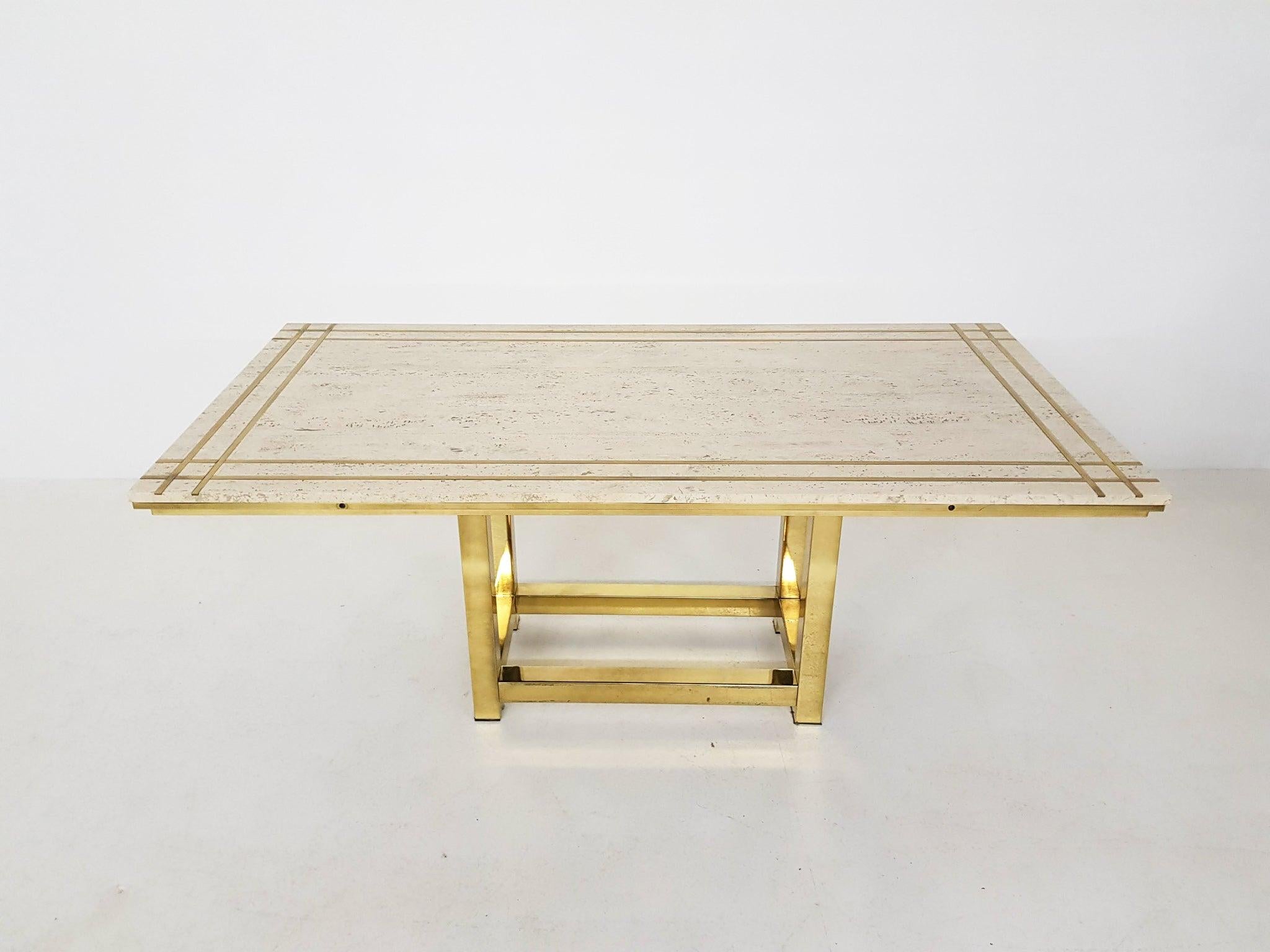 High-end travertine, brass and gold plated metal dining table by Alain Delon.

An impressive dining table made of the most beautiful travertine with a cross shaped brass inlay. The table rests on a gold plated metal base. It has place for six