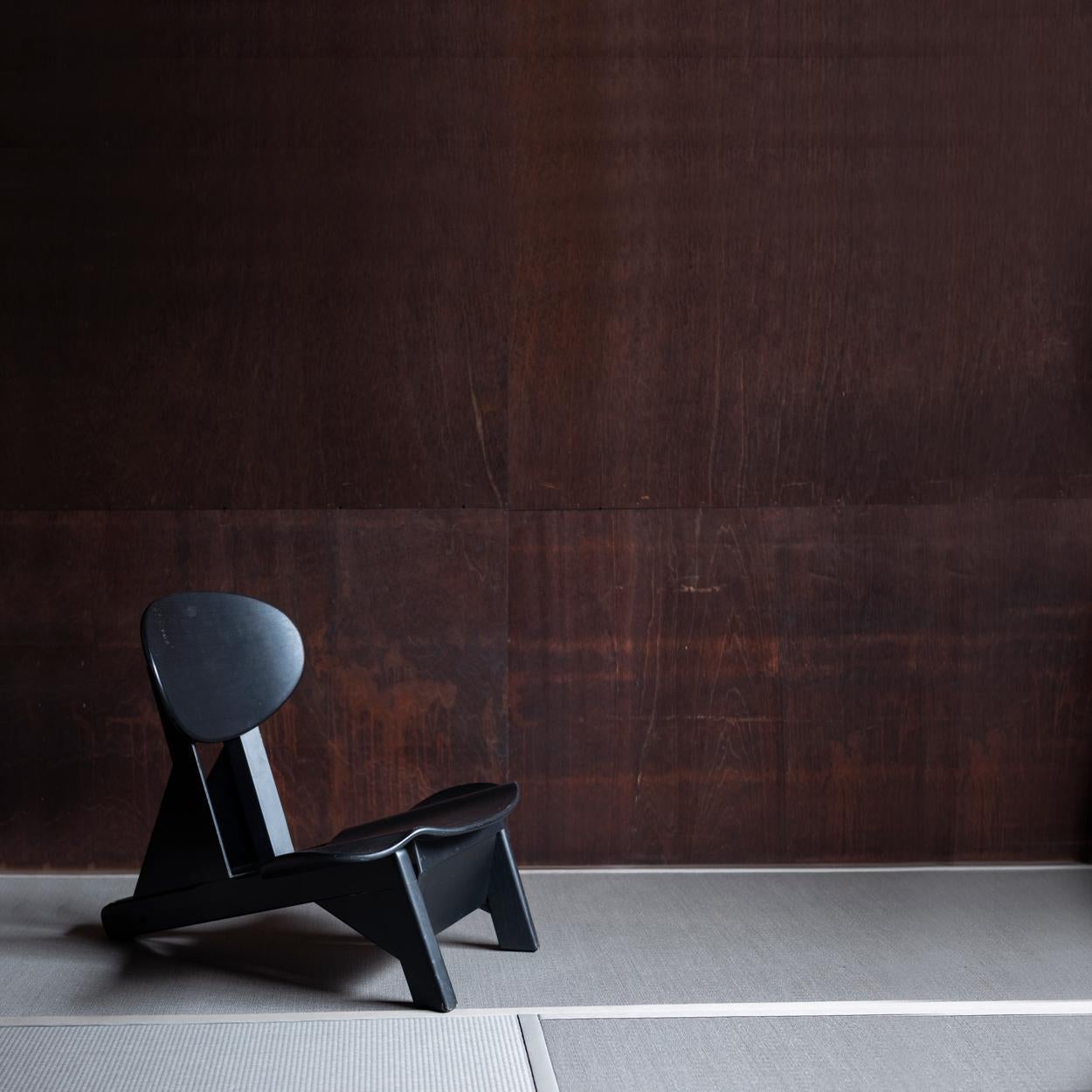 Rare and unique sculptural low chair in black designed by French designer Alain Gaubert.
The chair can be used in 3 different positions; to sit on the chair normally as a low chair, to sit on the back rest then it can be used as a stool, and to sit