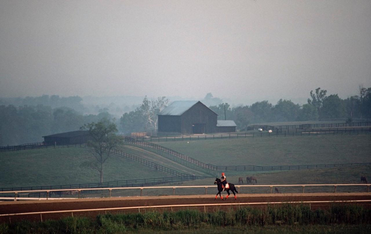 Frühmorgendlicher Ausritt von Alain Le Garsmeur
Ein Reiter trainiert ein Rennpferd am frühen Morgen, Churchill Downs, Louisville, Kentucky, USA, August 1984.

Papierformat 16 x 20 Zoll / 40 x 50 cm 
Gedruckt im Jahr 2022 - hergestellt von der