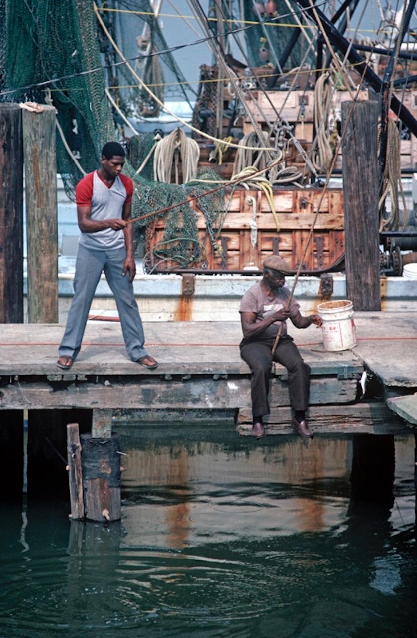 Fishing For Shrimp by Alain Le Garsmeur
African American fishermen fishing on a dock for shrimps, Savannah, Georgia, USA, 1983.

Paper size 40 x 30 inches / 101 x 76 cm   
Printed in 2022 - produced from the original transparency
Archival Pigment