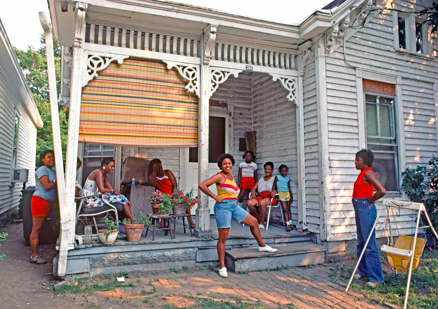 Happy Neighbours by Alain Le Garsmeur
An African American family relaxing outside their house in downtown Lexington, Kentucky, USA - August 1984.

Paper size 30 x 40 inches / 76 x 101 cm  
Printed in 2023 
Archival Pigment Print 
Signed and numbered