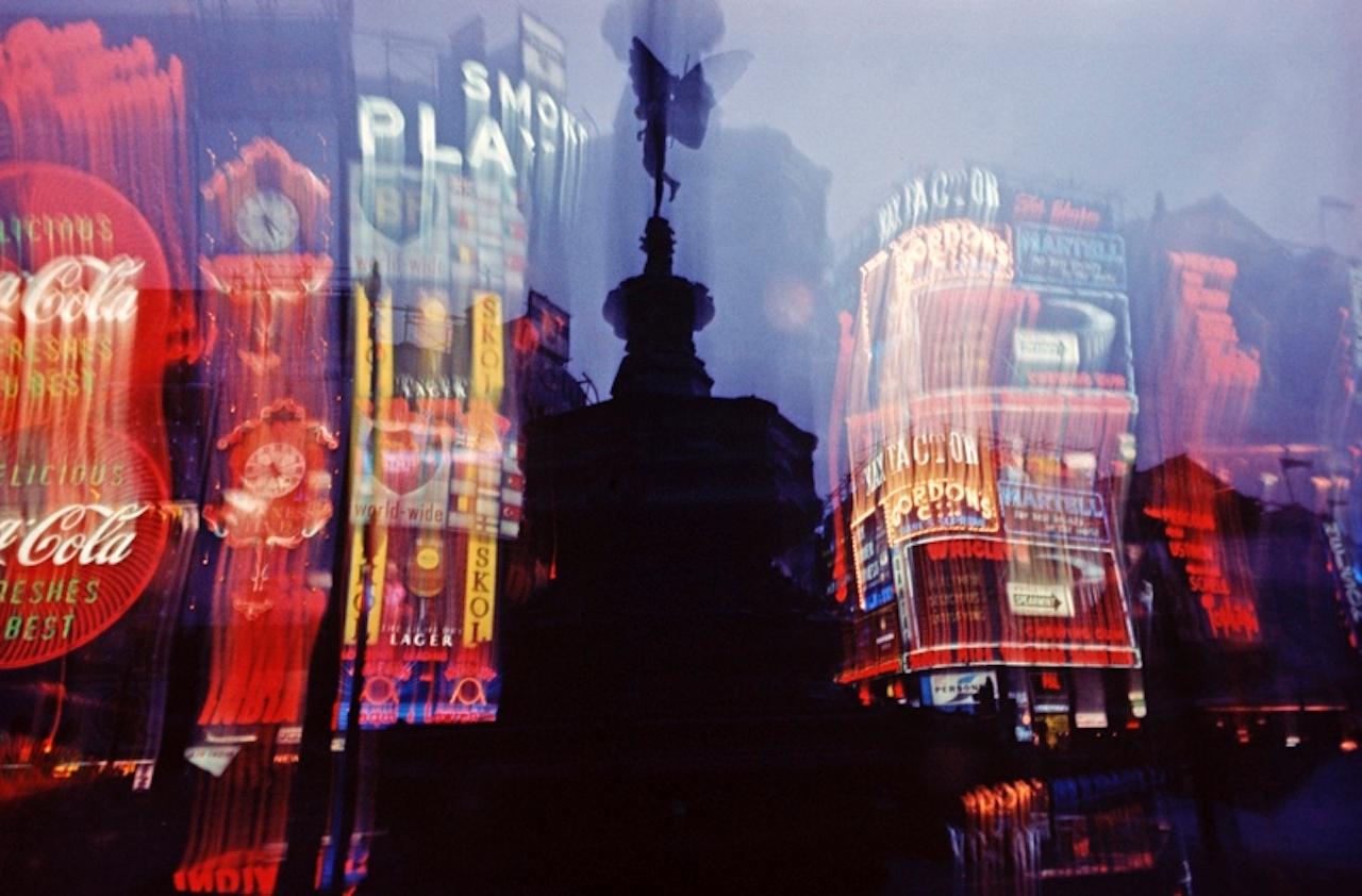 Piccadilly Lights by Alain Le Garsmeur
Neon advertisements shining behind the Eros Statue in Piccadilly, London, England, 1972.

Paper size 30 x 40 inches / 76 x 101 cm  
Printed in 2022 - produced from the original transparency
Archival Pigment