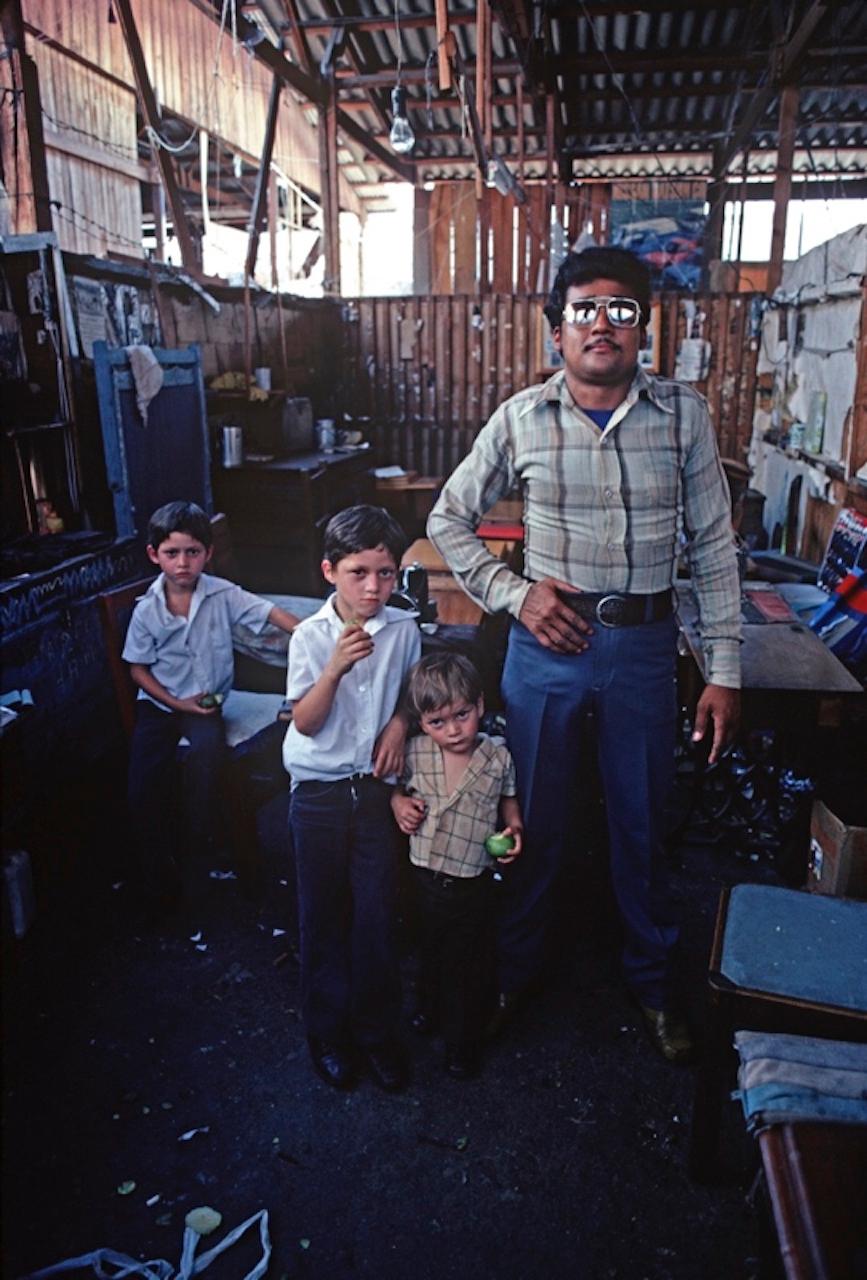 Prison Visit by Alain Le Garsmeur
A prisoner with his visiting children in Tegucigalpa main prison, Honduras, Central America, 1981.

Paper size 30 x 20 inches / 76 x 50 cm 
Printed in 2022 - produced from the original transparency
Archival Pigment