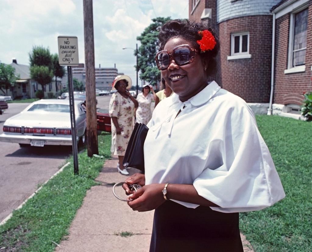 Sunny St Louis by Alain Le Garsmeur
A fashionable African American church member poses with sunglasses for the camera as she leaves a Baptist Congregation in St Louis, Missouri, USA, 1979.

Paper size 20 x 24 inches / 50 x 60 cm
Printed in 2022 -